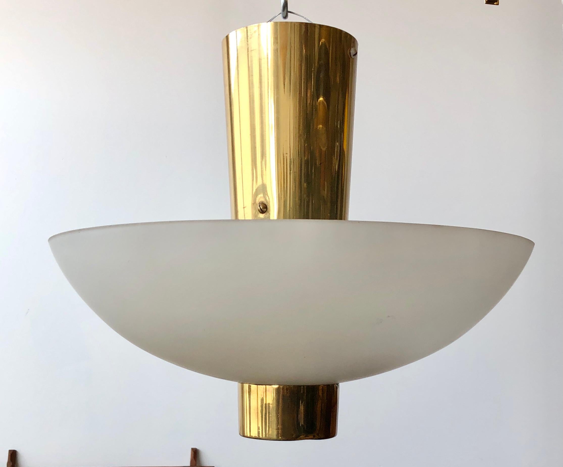 Ceiling light designed by Paavo Tynell for Idman, Finland circa 1950th.
Glass chade on polished brass frame. Four A27 sockets.
Similar example featured on idman catalog #140, Model 9045.
Some dents on bottom brass cup.
Rewiring available upon