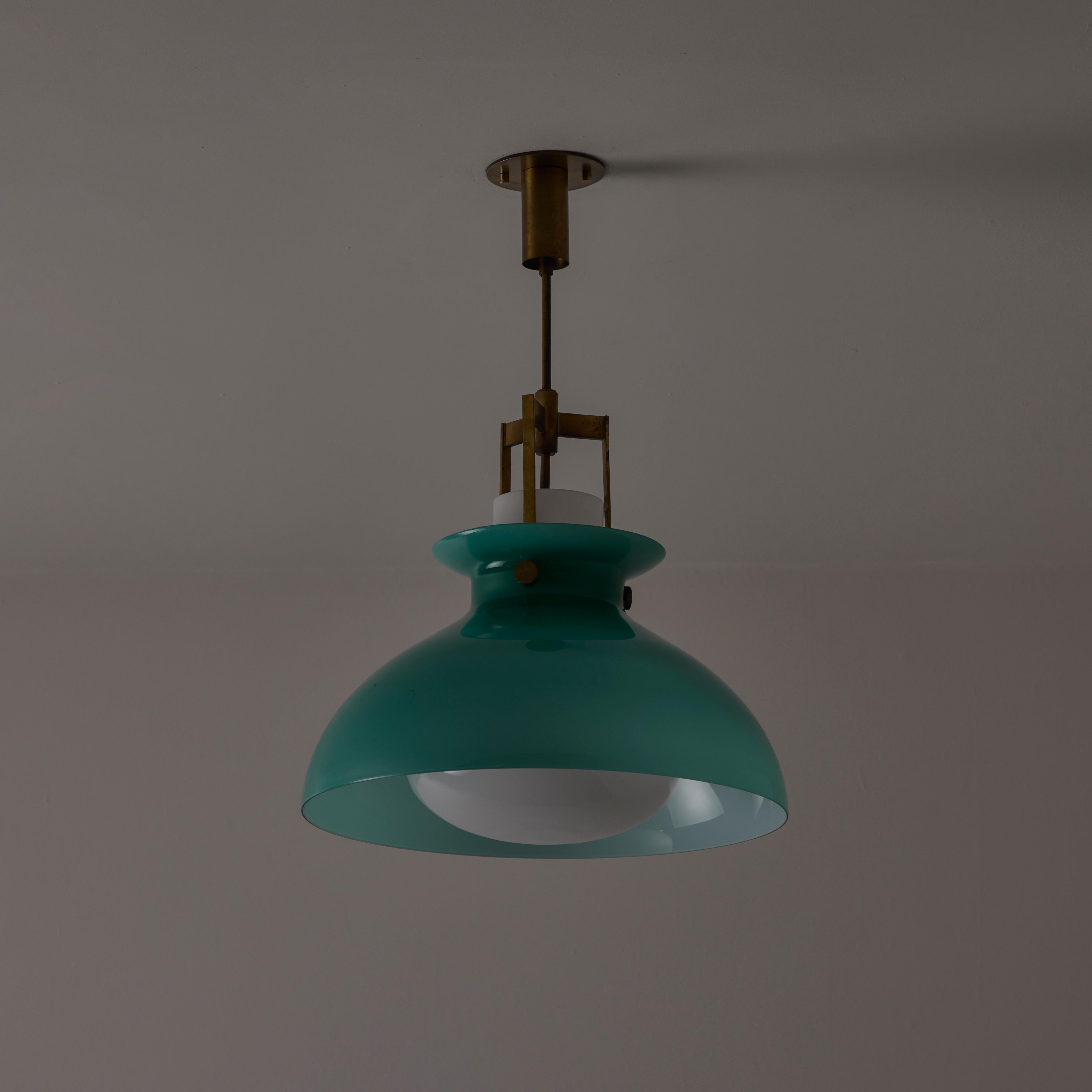 Ceiling light by Paolo Caliari for Venini. Designed and manufactured in Italy, circa the 1960s. Striking Venini pendant with an exterior green colored murano glass shade, encompassing an opal interior shade. The glass components are suspended by a