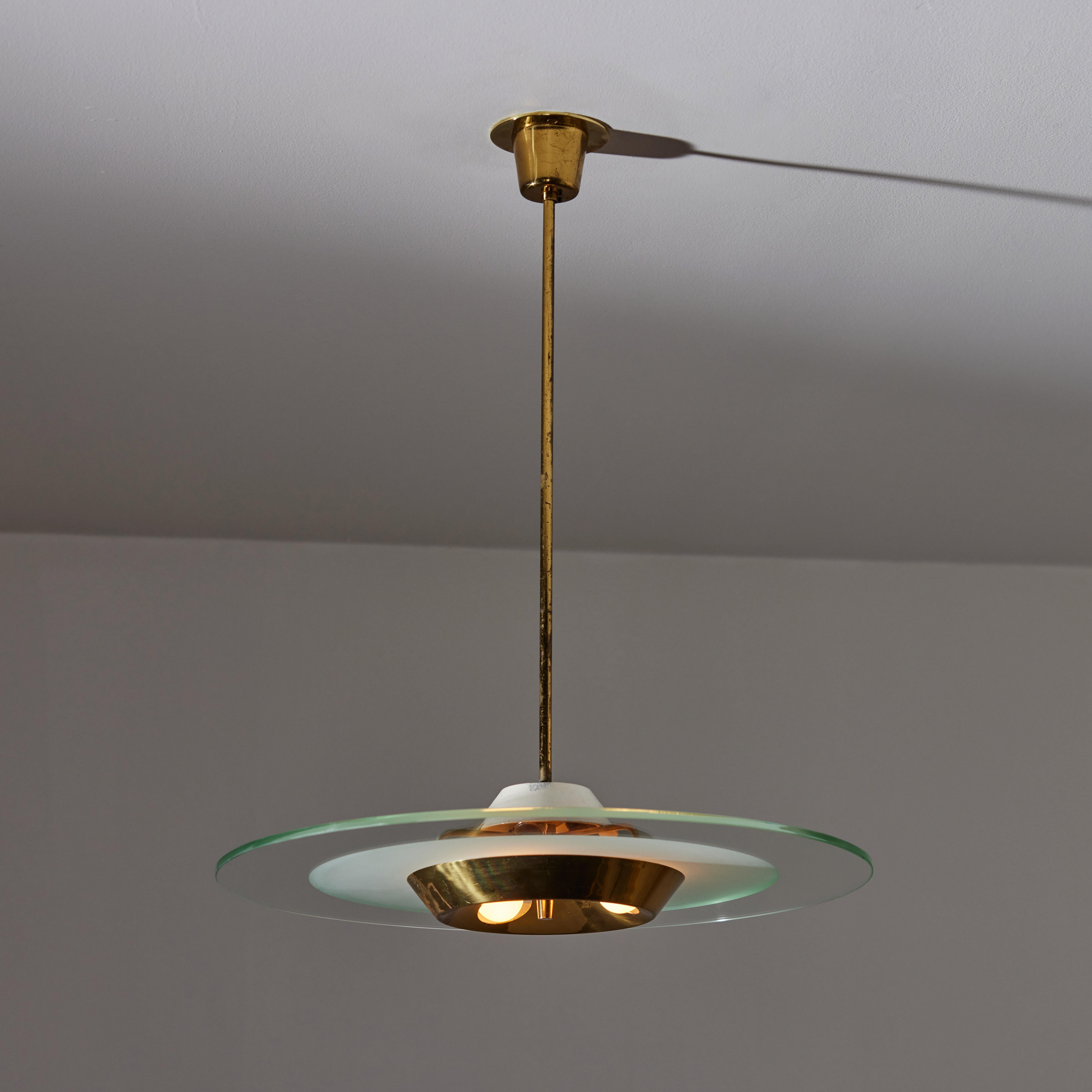 Ceiling light by Stilnovo. Manufactured in Italy, circa the 1950s. Features a large clear blue and etched glass disc paired with a brass diffuser cap. Aged polished brass hardware throughout. Rewired for U.S. standards. Original canopy, custom brass