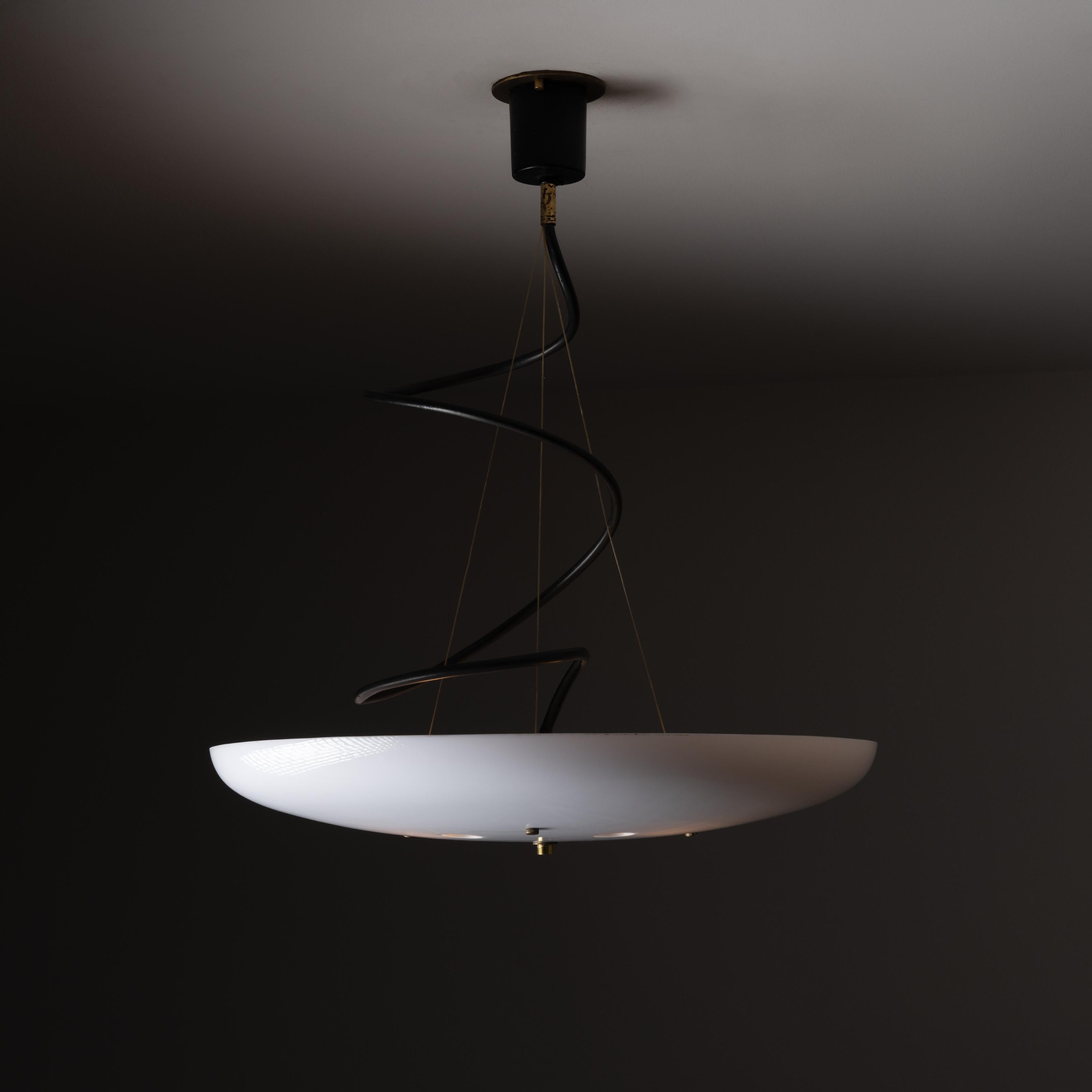 Ceiling light by Stilnovo. Designed and manufactured in Italy, circa 1960s. Suspended pendant with coiled wiring, and circular acrylic shell with five small circular die-cuts. We recommend using three 40w maximum E27 bulbs. Rewired for US standards.