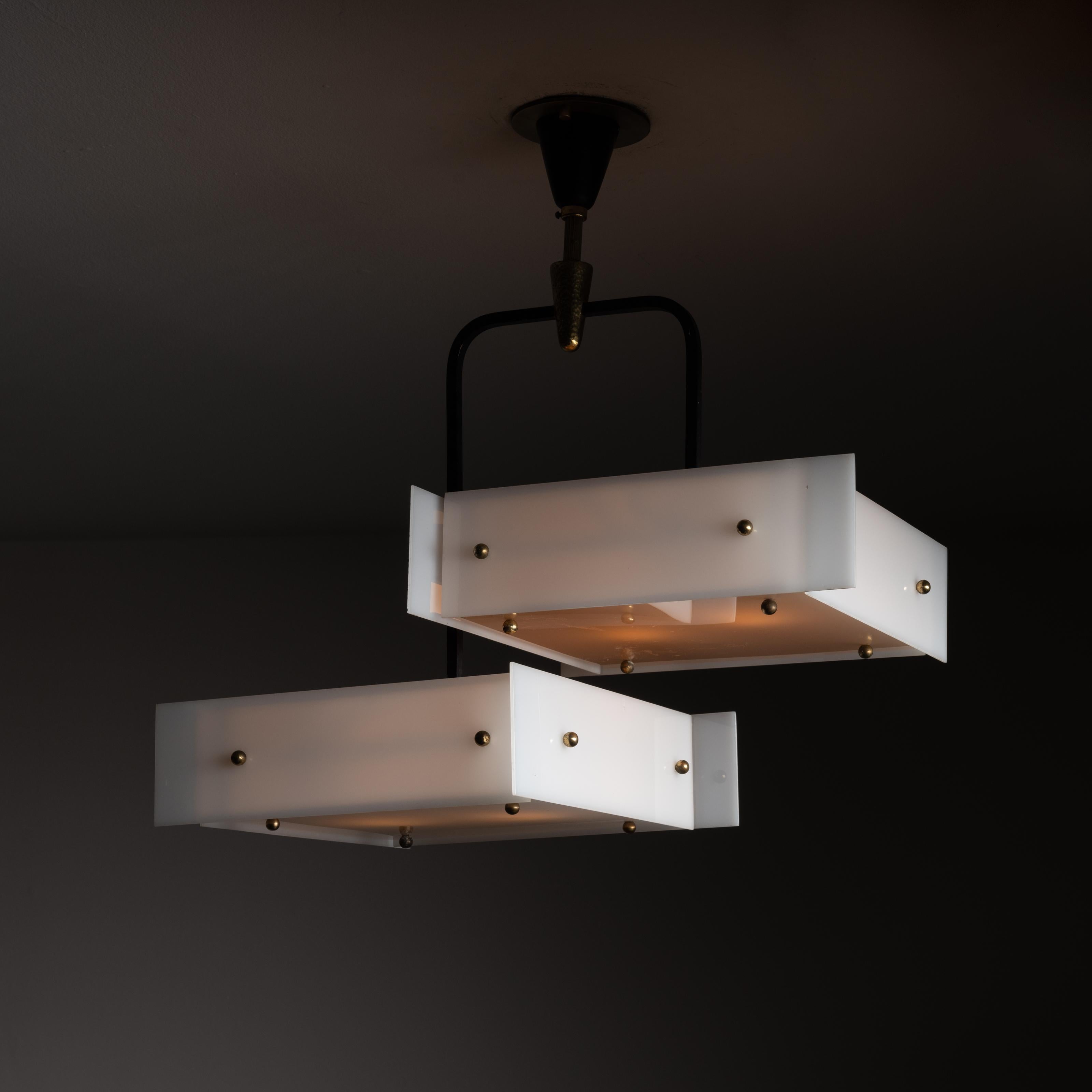 Ceiling light by Stilux. Designed and manufactured in Italy, circa the 1960s. Lucite paneled light boxes are suspended by a two armed enamel rods. Canopy has a hammered brass coupling. Custom backplate for US standards. Holds four e14 socket types,