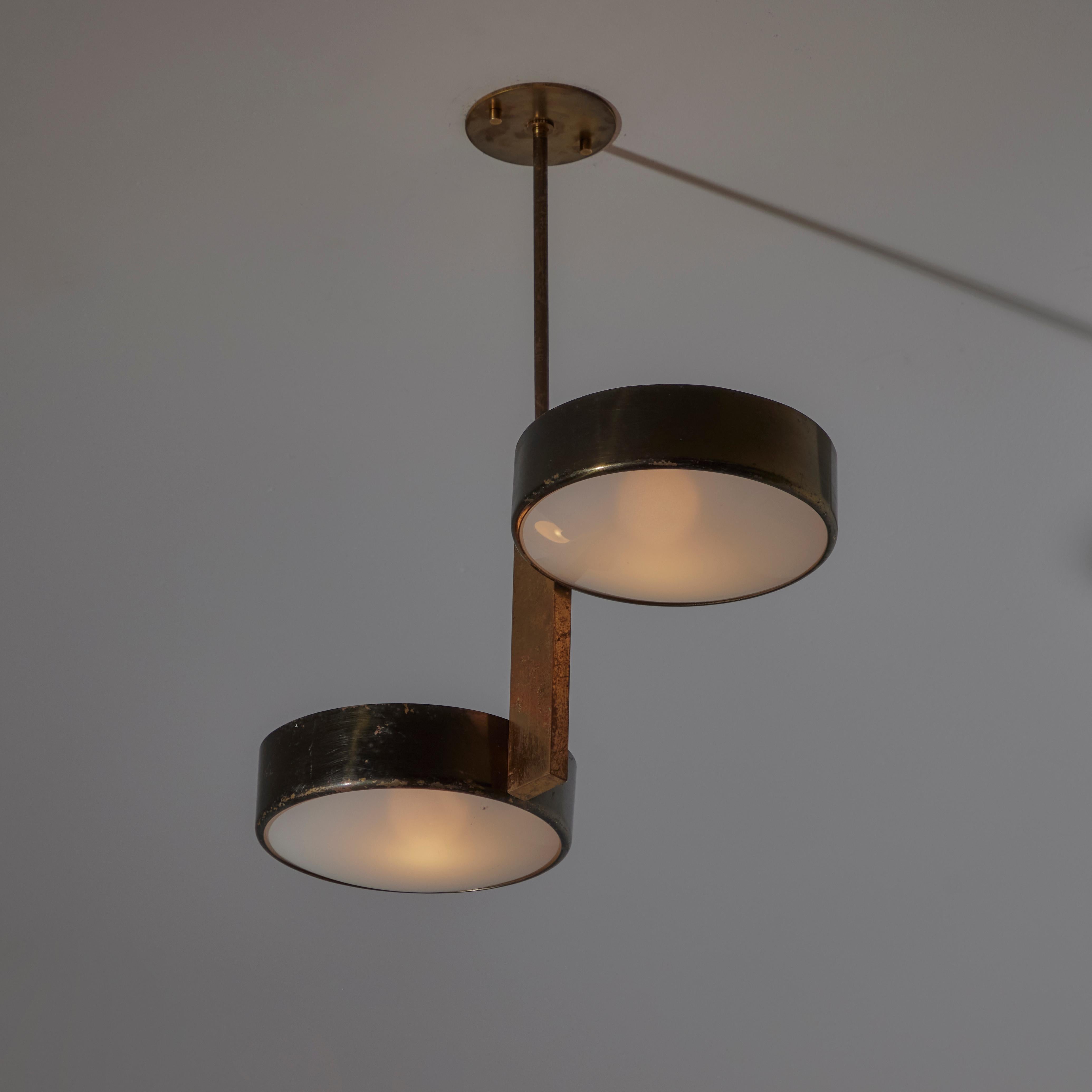 Ceiling light by Stilnovo. Designed and manufactured in Italy, circa the 1950s. Double-tiered black enameled shade holders are offset on a brass pendant stem. The diffusers are made of etched glass. Each diffuser holds an E27 socket type, adapted
