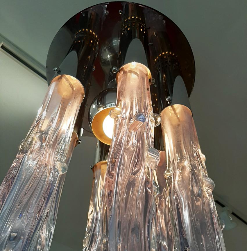 Stunning ceiling chandelier in a transparent purple/pink tint Murano glass attached to a chromed metal plate. The carved pieces of glass are shaped like ice spikes. ‘Excalibur’ series, designed by Ettore Fantasia and Gino Poli for a 1970s Sothis