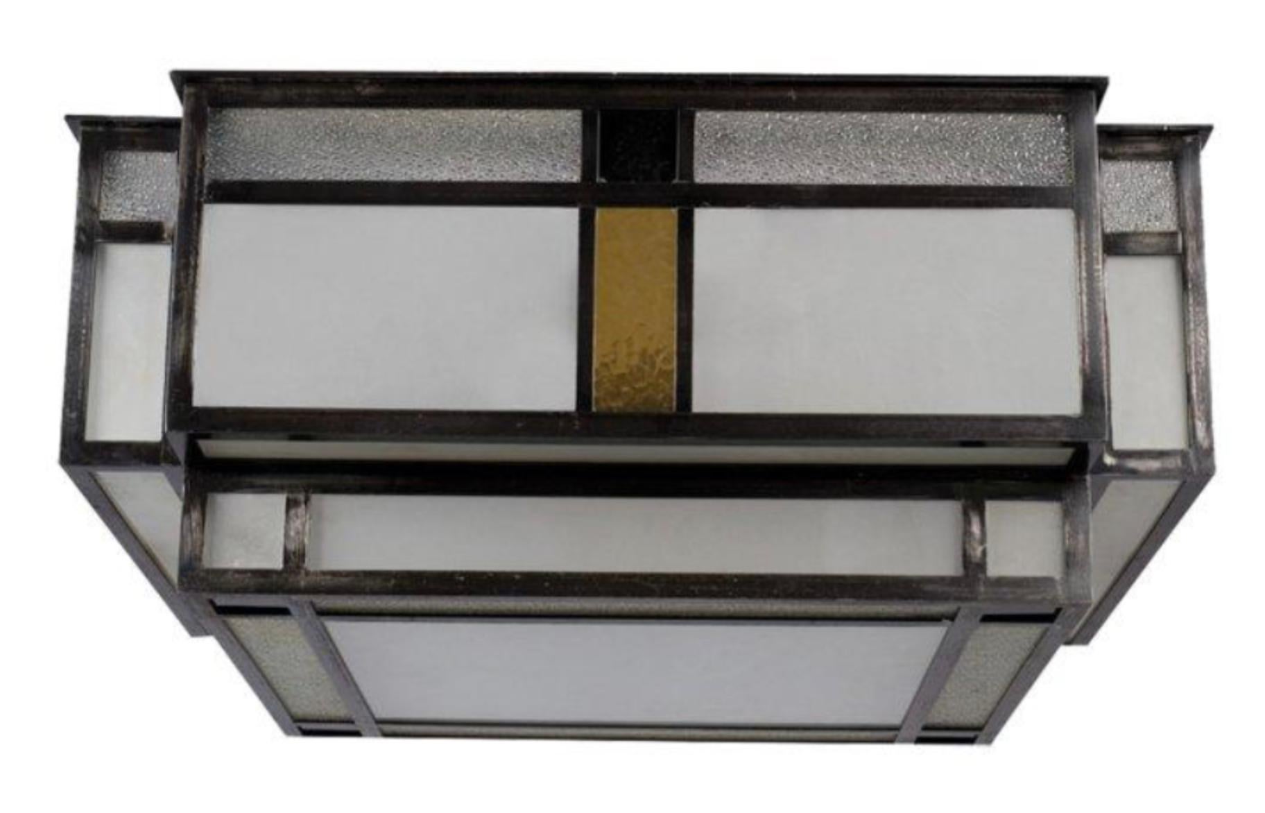 Modernist ceiling light in a two-level square shape, patinated metal structure encircling cut glass, satin, granite and coloured plates.
A pair is available.