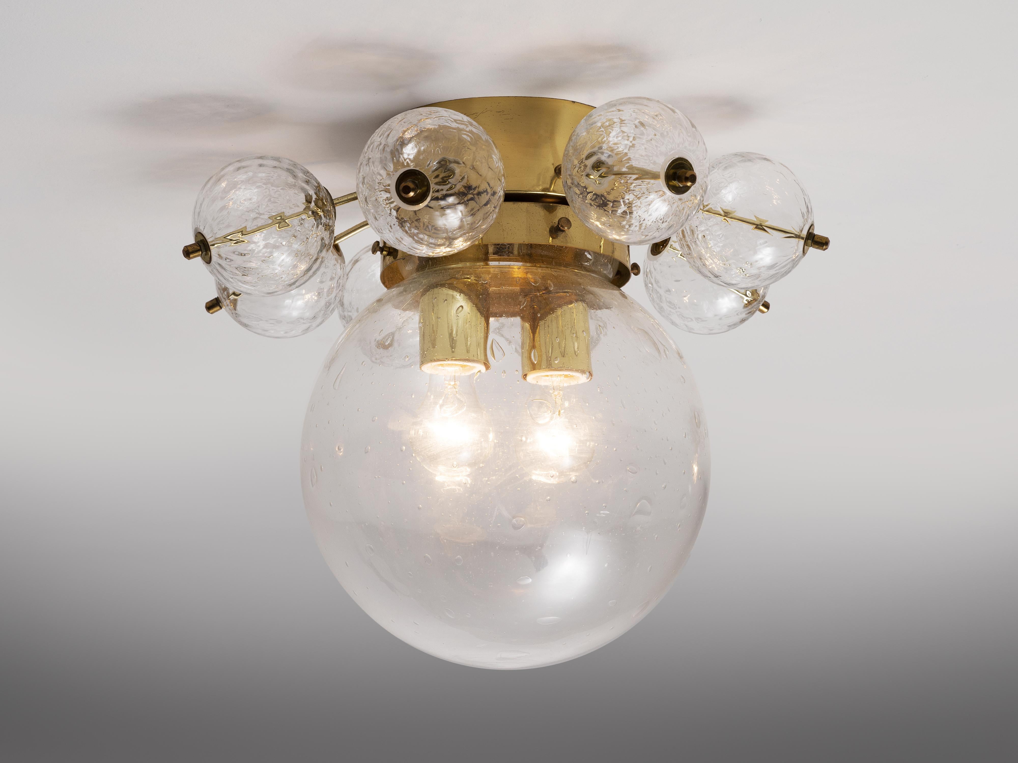 Ceiling light in glass and brass, Europe, 1970s.

Beautiful ceiling light in brass and structured glass. This piece is manufactured in Europe in the 1970s. Consisting of one large sphere of slightly structured glass with two-light points. Decorated