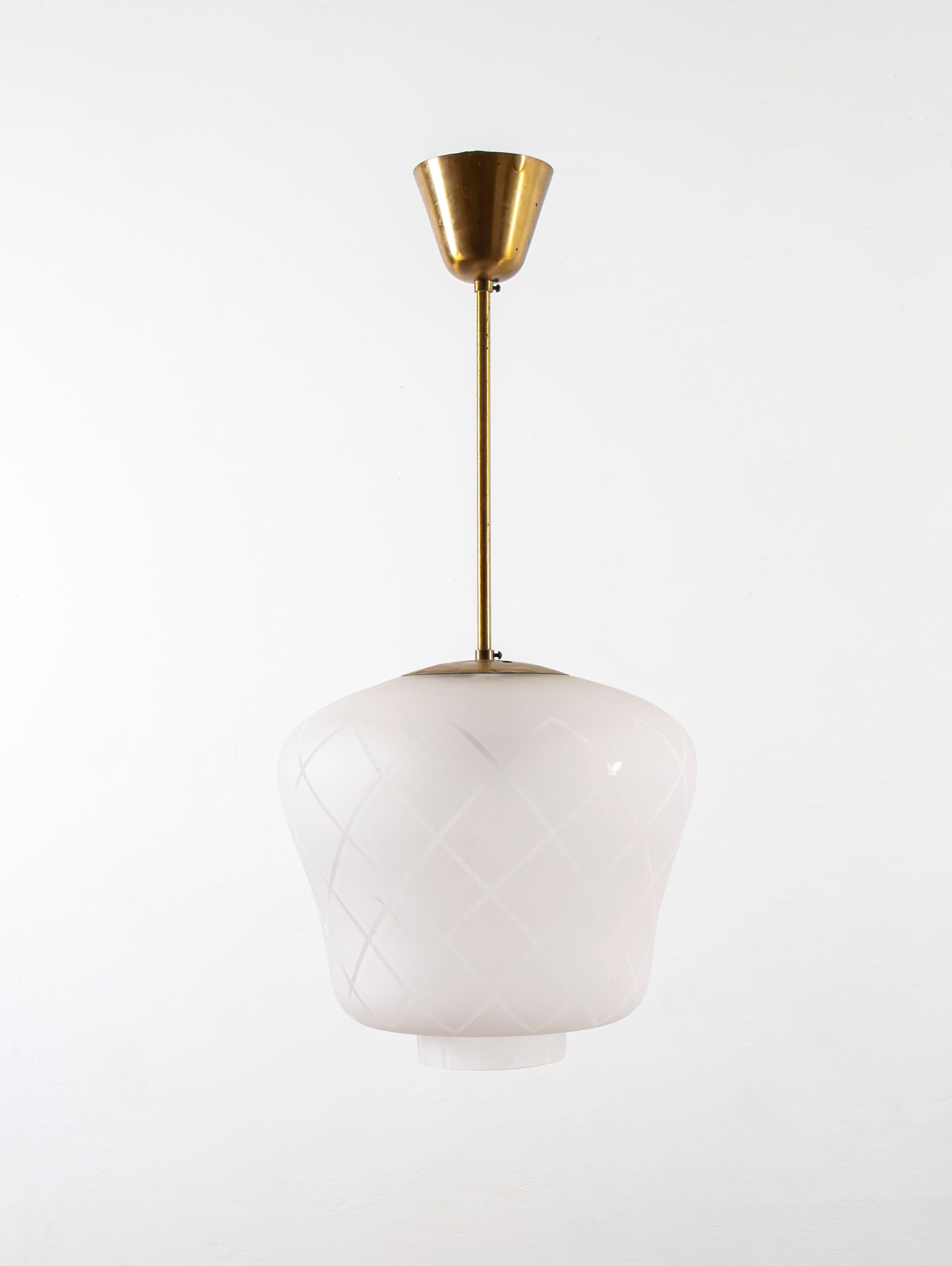 Wonderful ceiling lamp with a brass stem and cup. The shade is made in frosted glass with a decorated surface. Designed by Birger Dahl and made in Norway for Sønnico AS from circa 1960s first half. The lamp is fully working and in very good vintage