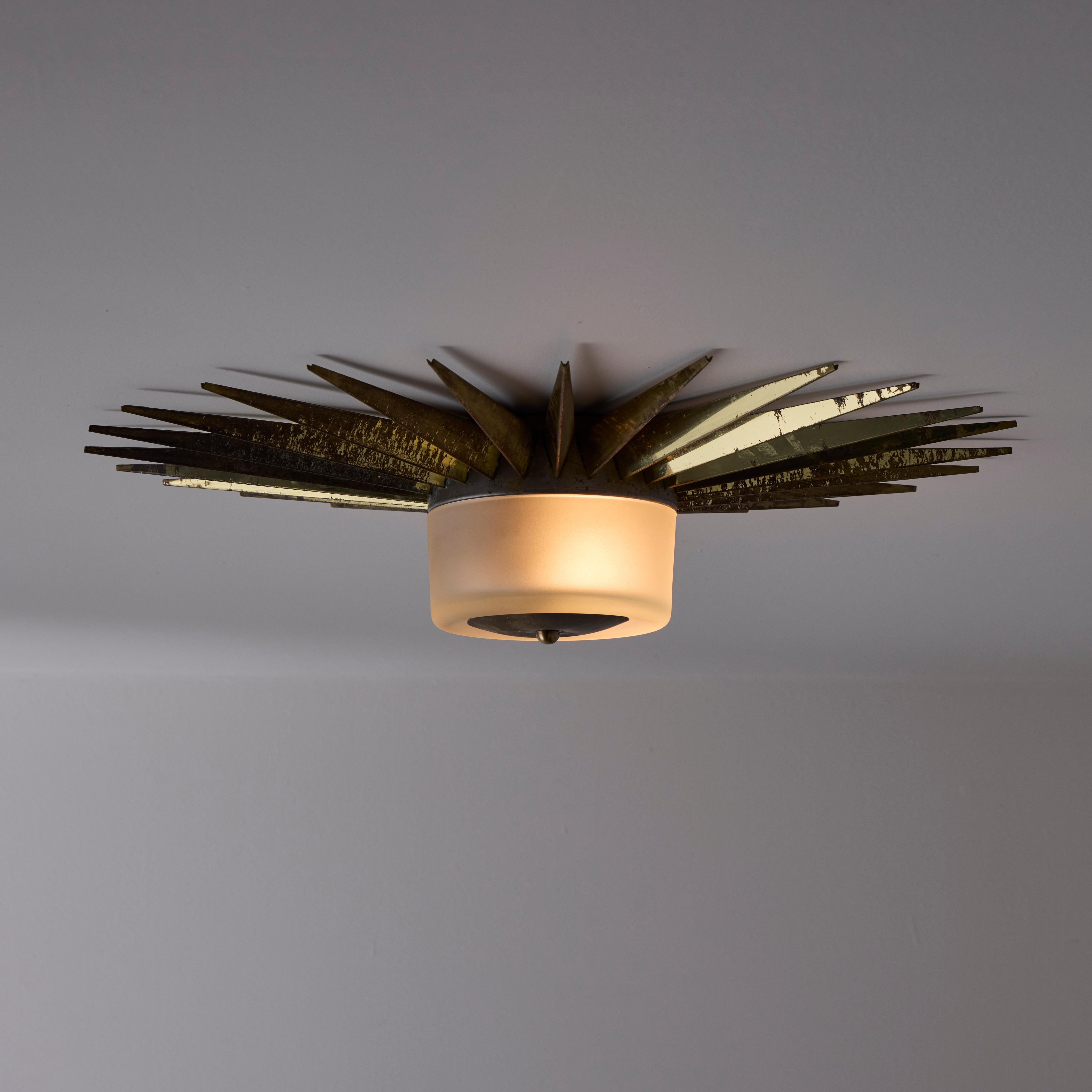 Ceiling Light In The Style of Arredoluce. (Italy, 1950s)

Gothic style flushmount comprising of a central sandblasted glass diffuser and aged brass rays encompassing the fixture. All brass details offer gorgeous patina. The light holds a double E27