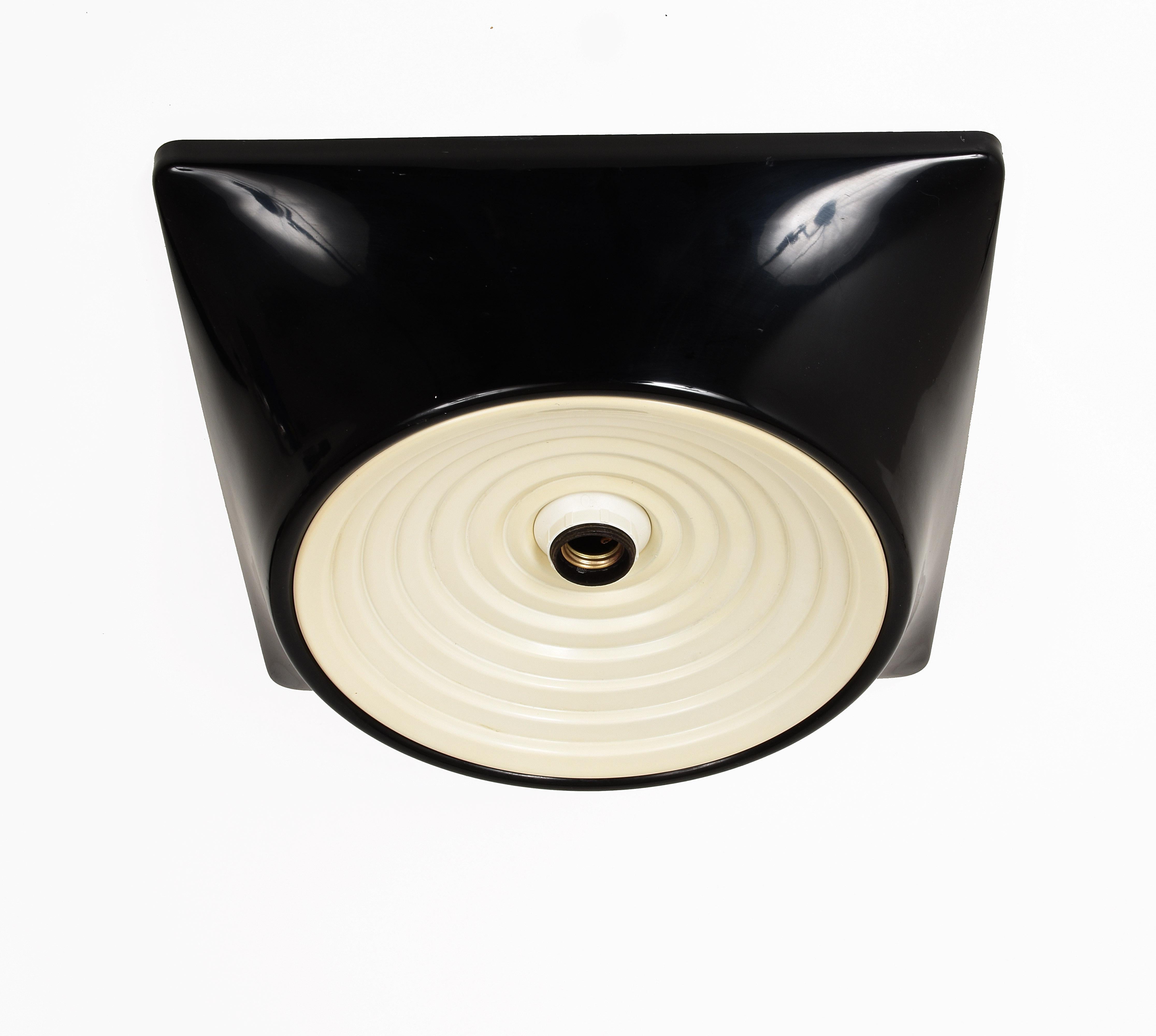 Ceiling light model 1369
designed by Studio Nizzoli Associati
for Stilnovo in 1969.
Resin printed support
of color black.
Reflective disc
in white metal.
Relief marking
