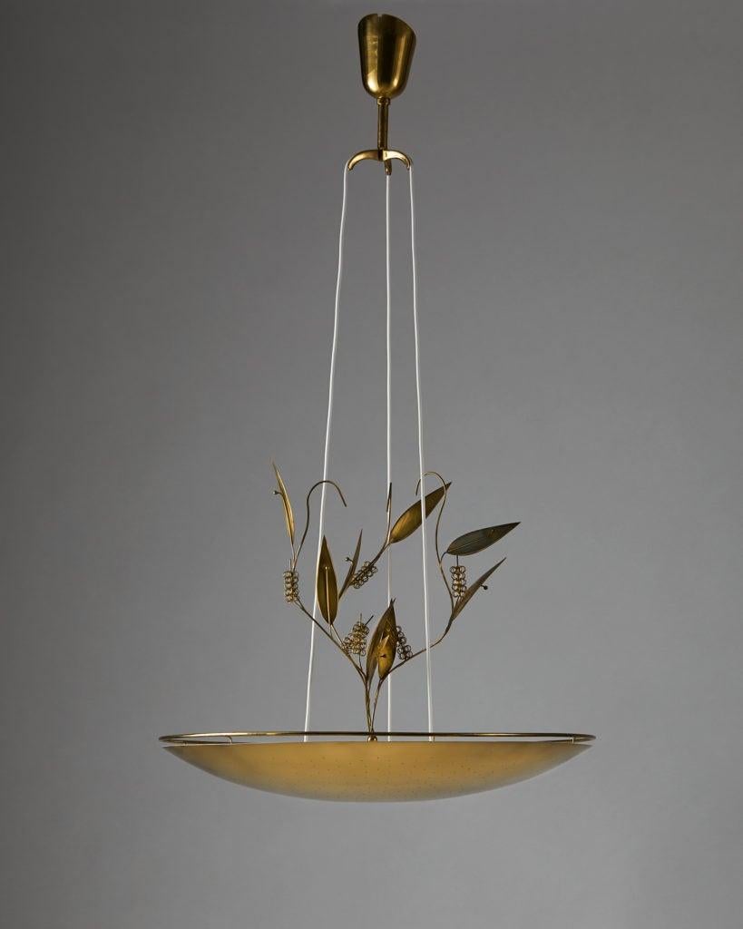 Ceiling light model K2-33 designed by Paavo Tynell for Taito Oy,
Finland, 1950s.

Pierced brass. 

These lights were made to order, and were designed for Church Kuopio in Finland.