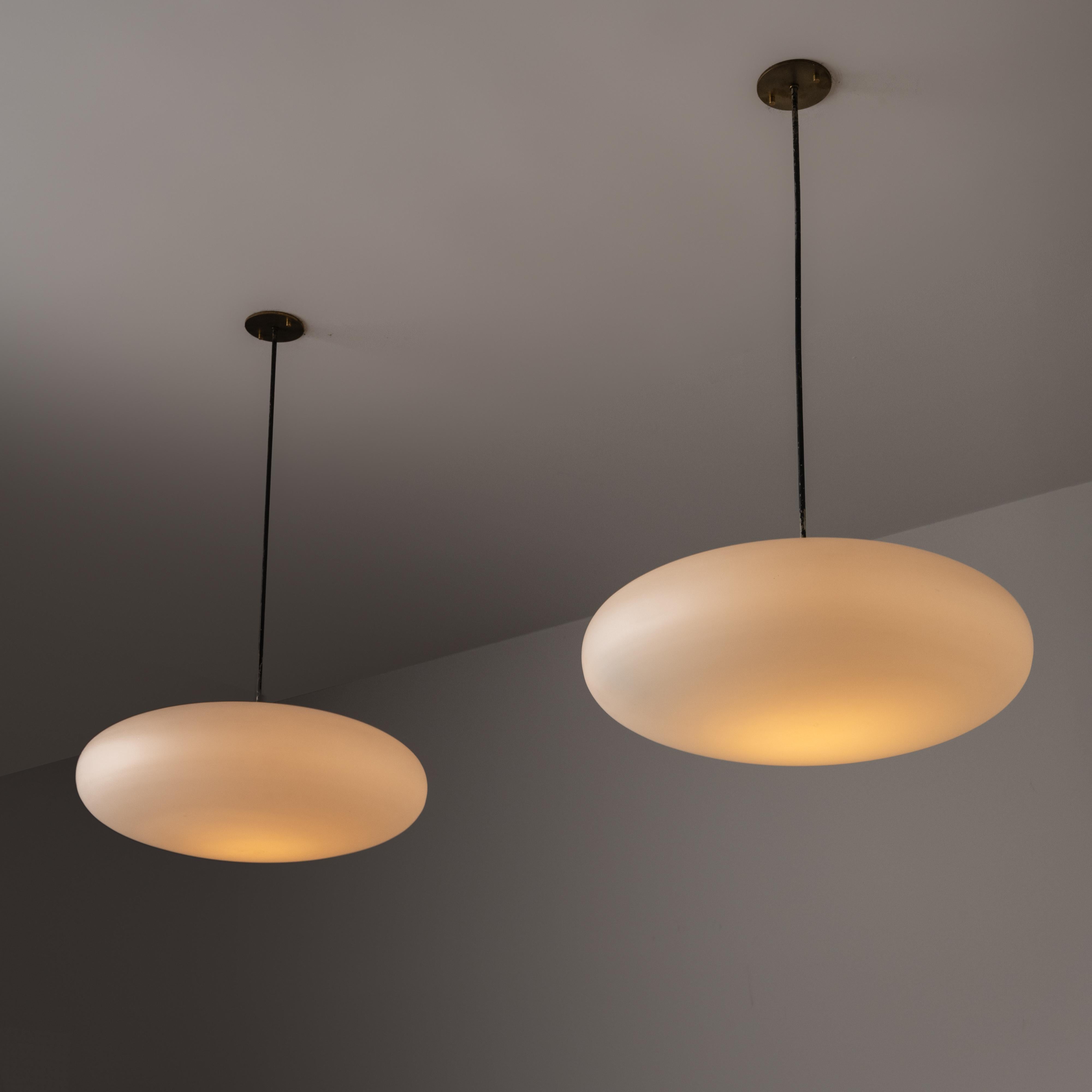 Ceiling Light by Stilnovo. Designed and manufacturered in Italy, circa the 1960s. Simplistic orb pendant with an enameled steel stem suspension. Very subtle and striking illumination from the saucer shaped glass. The fixture holds a single E27