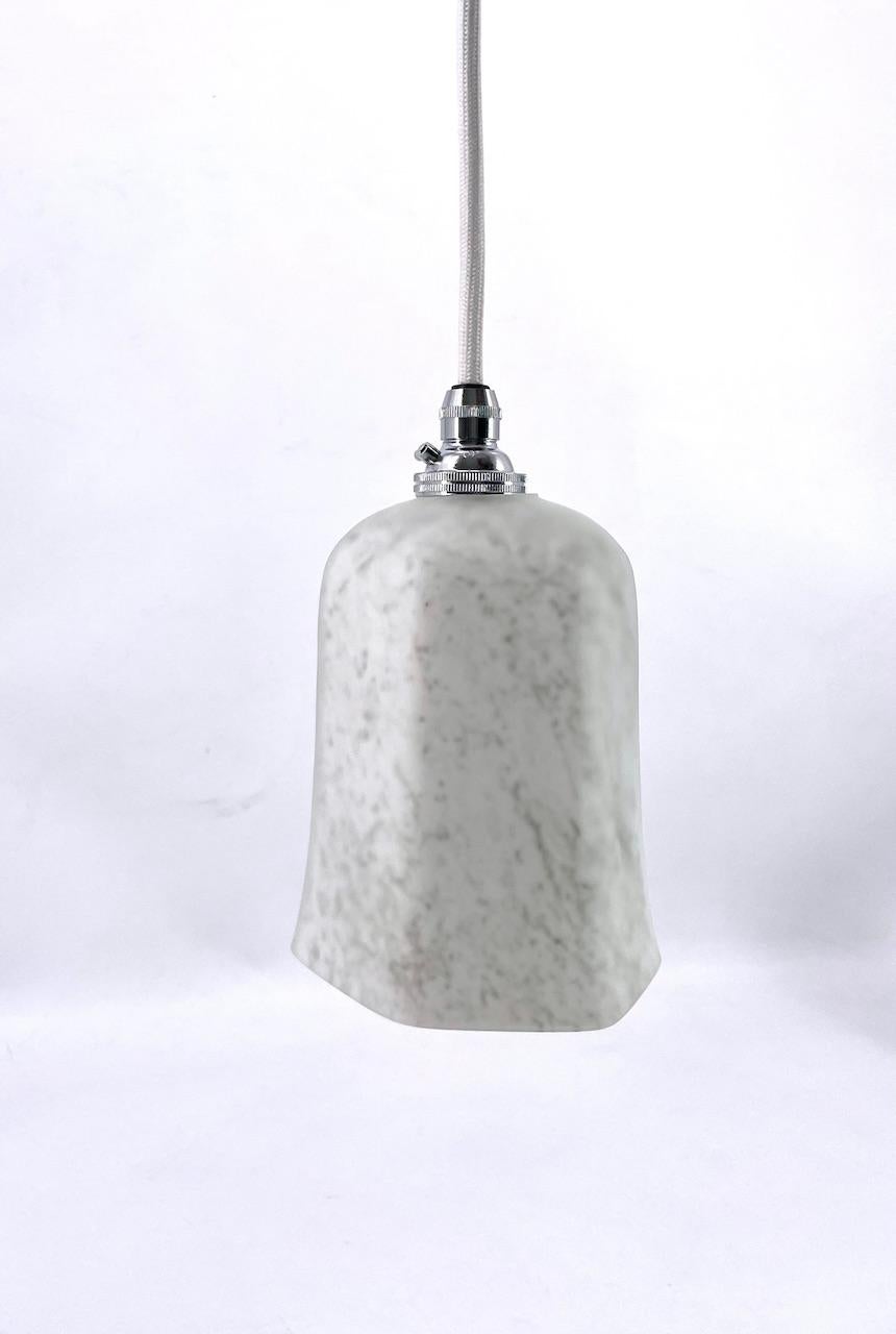 This art deco pendant with grey-green veins has an appearance similar to marble or alabaster. This light is made of multiple layers of glass making a beautiful effect of mat and silky aspect The light is soft to the eye.

The pendant delicately