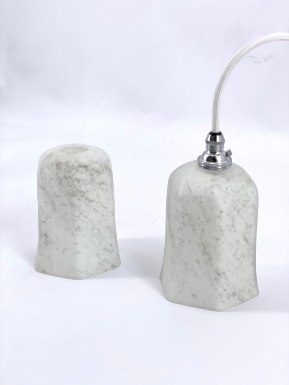 This art deco pendant with grey-green veins has an appearance similar to marble or alabaster. This light is made of two layers of glass with the inside white making a beautiful effect of mat and silky aspect The light is soft to the eye.

The