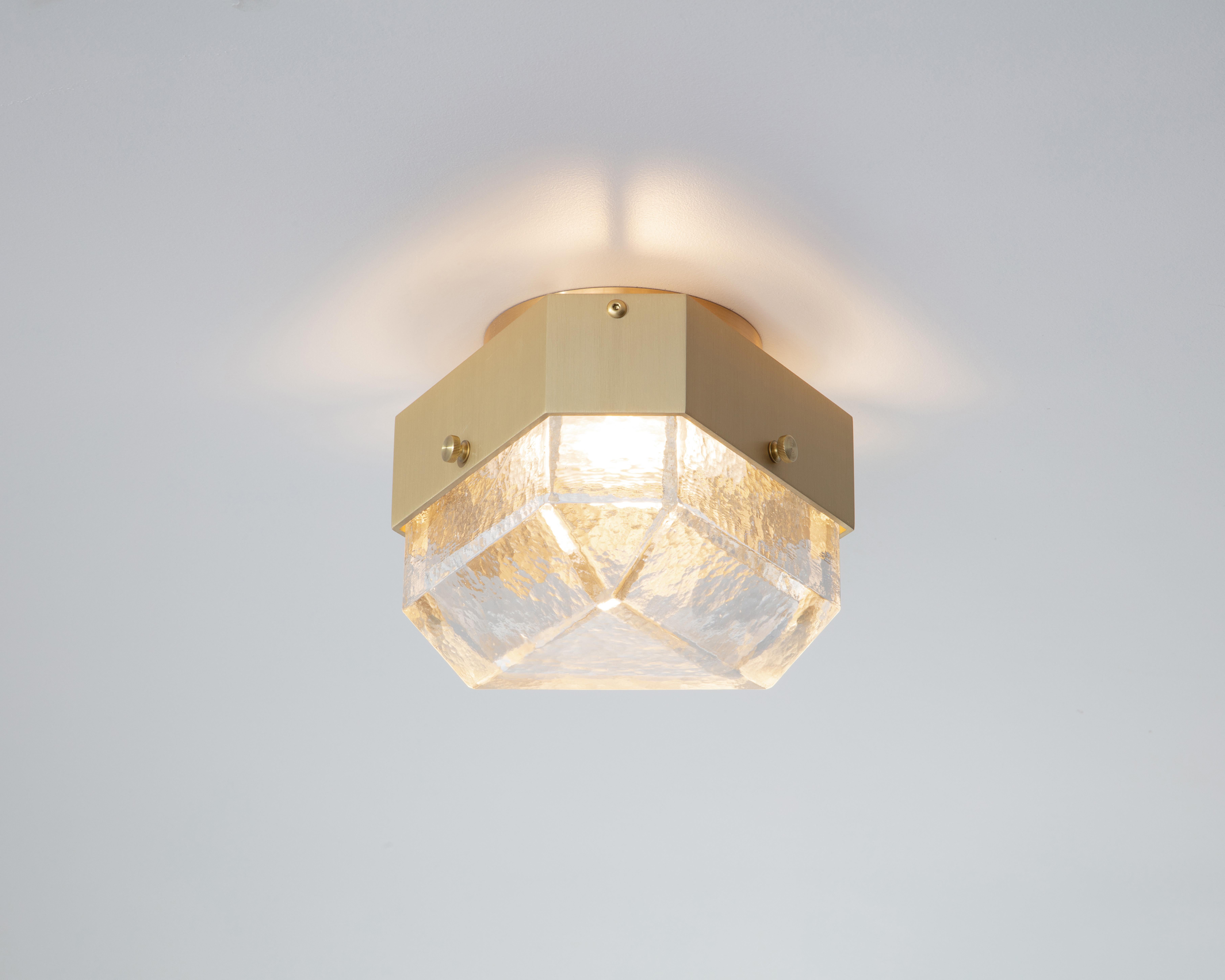 The Vega Uno is a geometric, modular, contemporary lighting fixture. Vega is suitable for installation on the ceiling as a flush mount, or on the wall as a sconce. The body is made from extruded aluminum with brass accents. The diffusers are cast