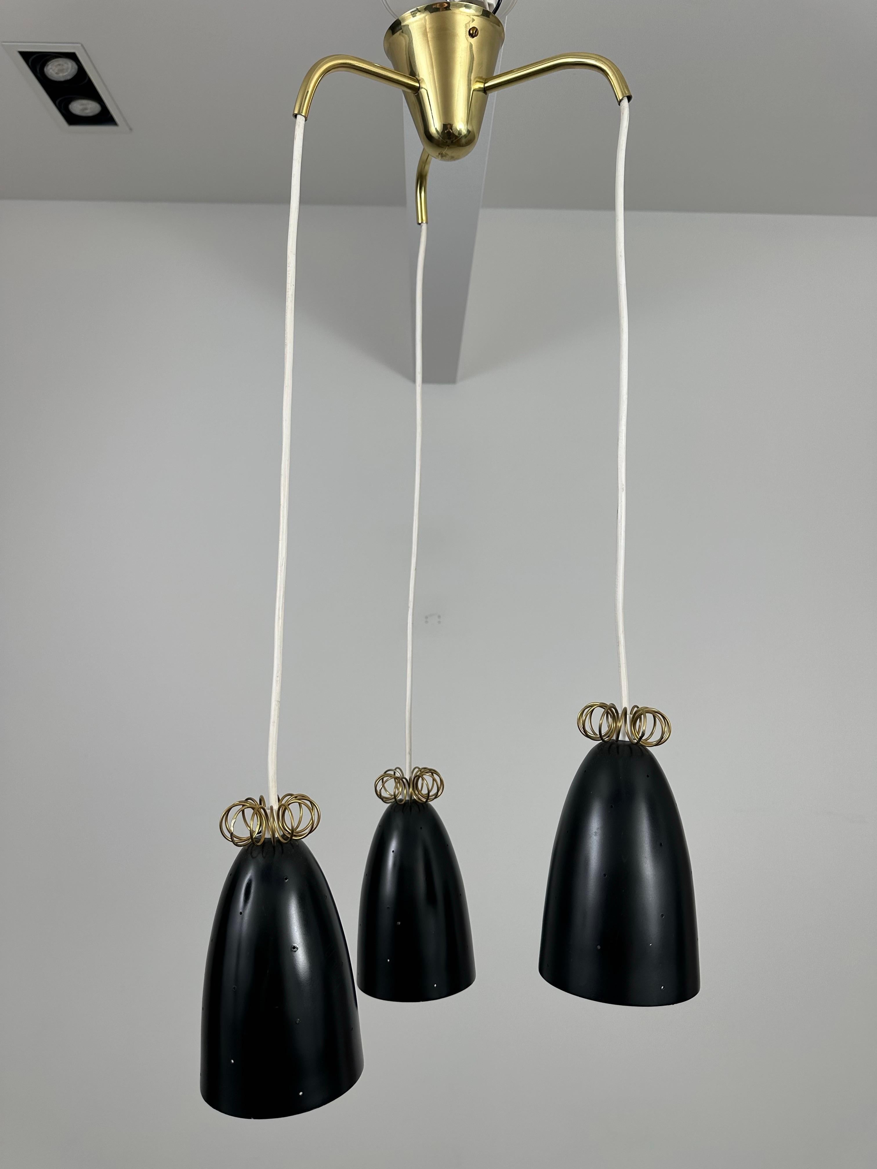 Este colgante de techo de tres piezas se diseñó durante la década de 1950 en Finlandia.  Itsu, abreviatura de Itä-Suomen Sähkö (eng. Electricidad de Finlandia Oriental), era una pequeña fábrica menos conocida que producía modelos característicos en