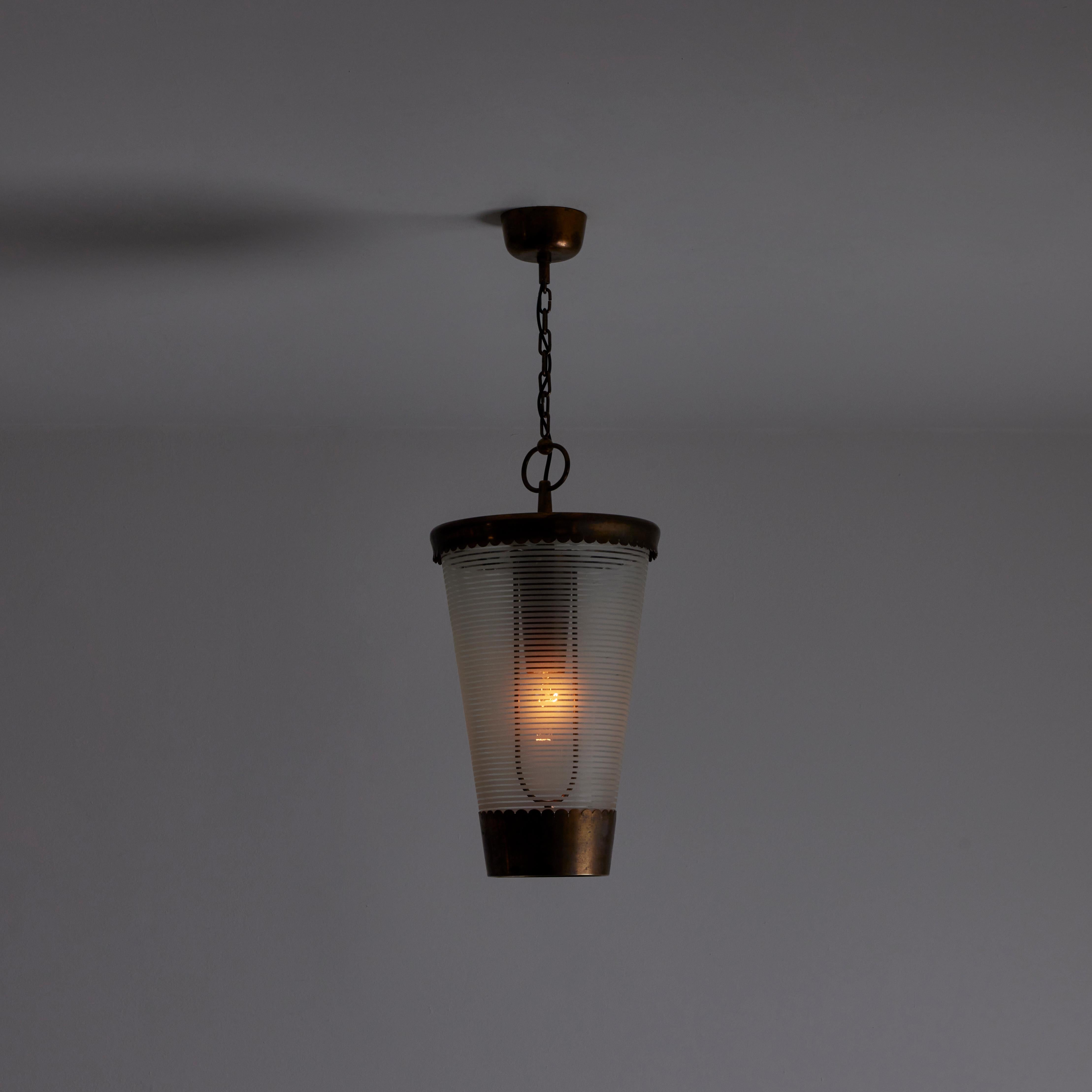 Ceiling Pendant by Pietro Chiesa for Fontana Arte. Designed and manufactured in Italy, circa 1940. Unique tapered cylindrical pendant with antique brass frame and custom striped glass shade. This chandelier is suspended by original brass chain links