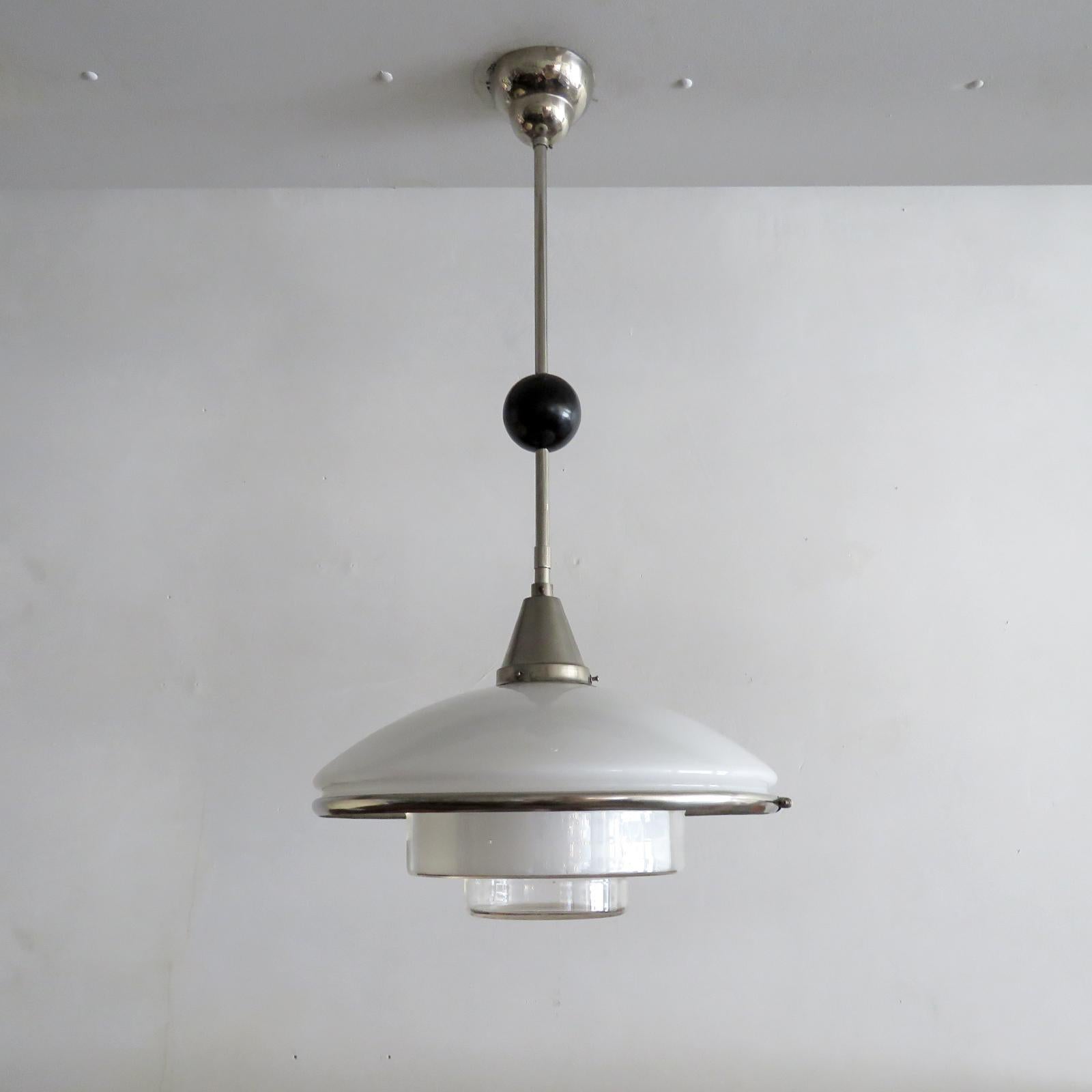 Wonderful pendant light 'P4' designed by Otto Müller for Sistrah Licht and Megaphos Germany, 1931, composed of two main glass elements, a white opaline glass dome and an inverted ziggurat shaped clear glass shade with nickel-plated belt, nickel