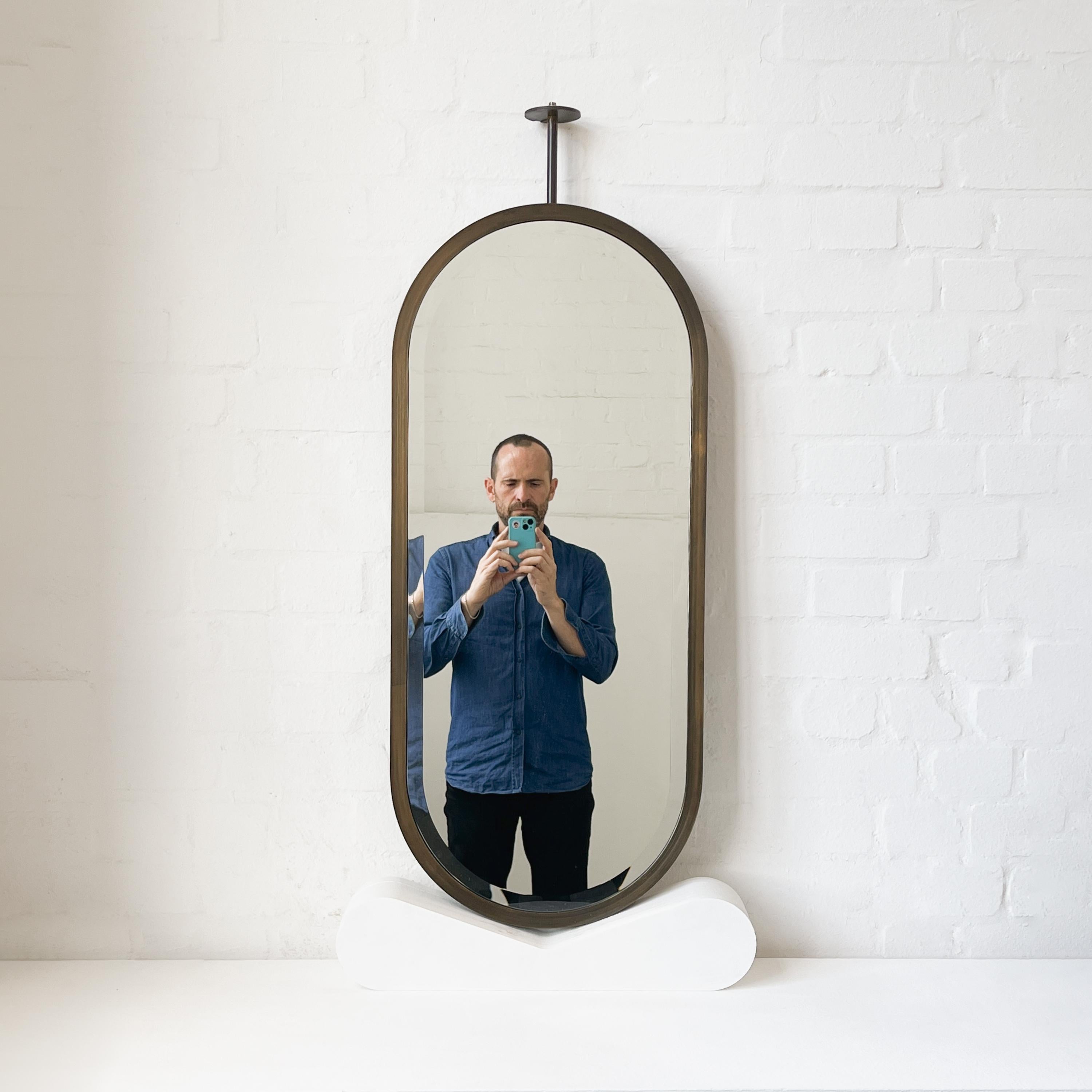 British Ceiling Suspended Capsula Pill shaped Bevelled Mirror with Bronze Patina Frame For Sale