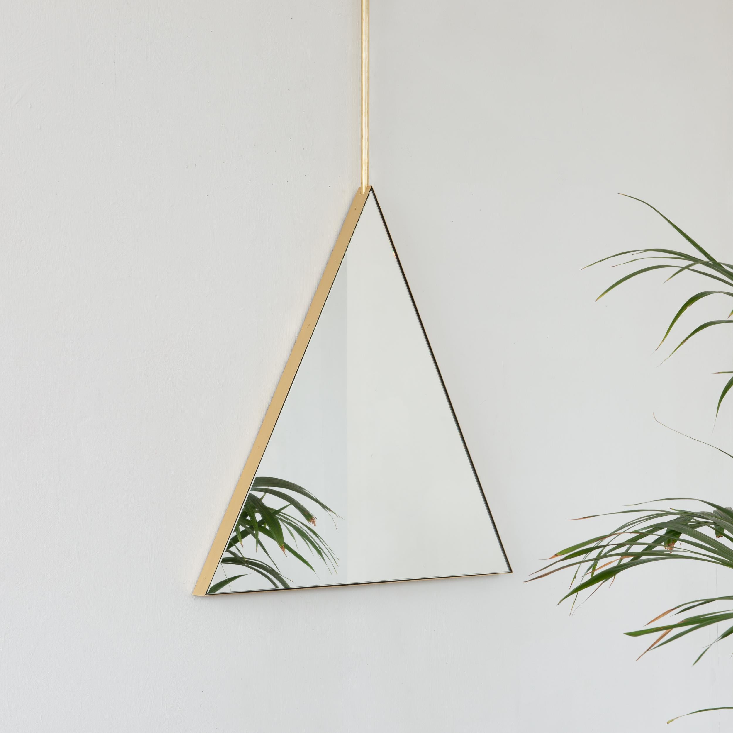 Original and unique ceiling suspended triangular mirror with an elegant solid brushed brass frame. Designed and handcrafted in London, UK, our unique and elegant collection of ceiling suspended mirrors is fully customisable to suit the specific