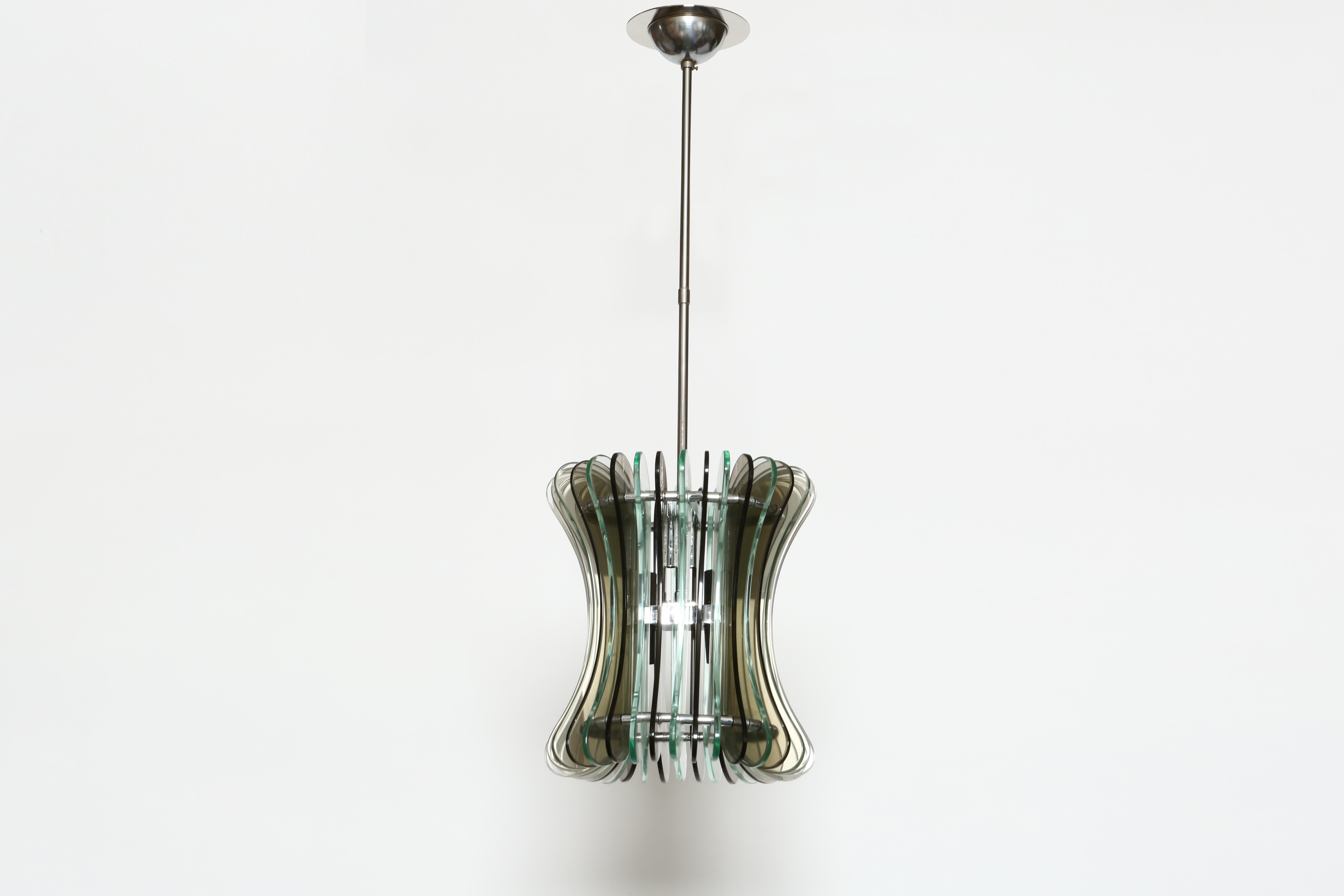 Suspension ceiling light by Veca.
Designed and manufactured in Italy in 1970s
Smoked colored glass in 2 tones, chrome plated frame.
Height adjustable.
Four candelabra sockets.
Complimentary US rewiring upon request.
 