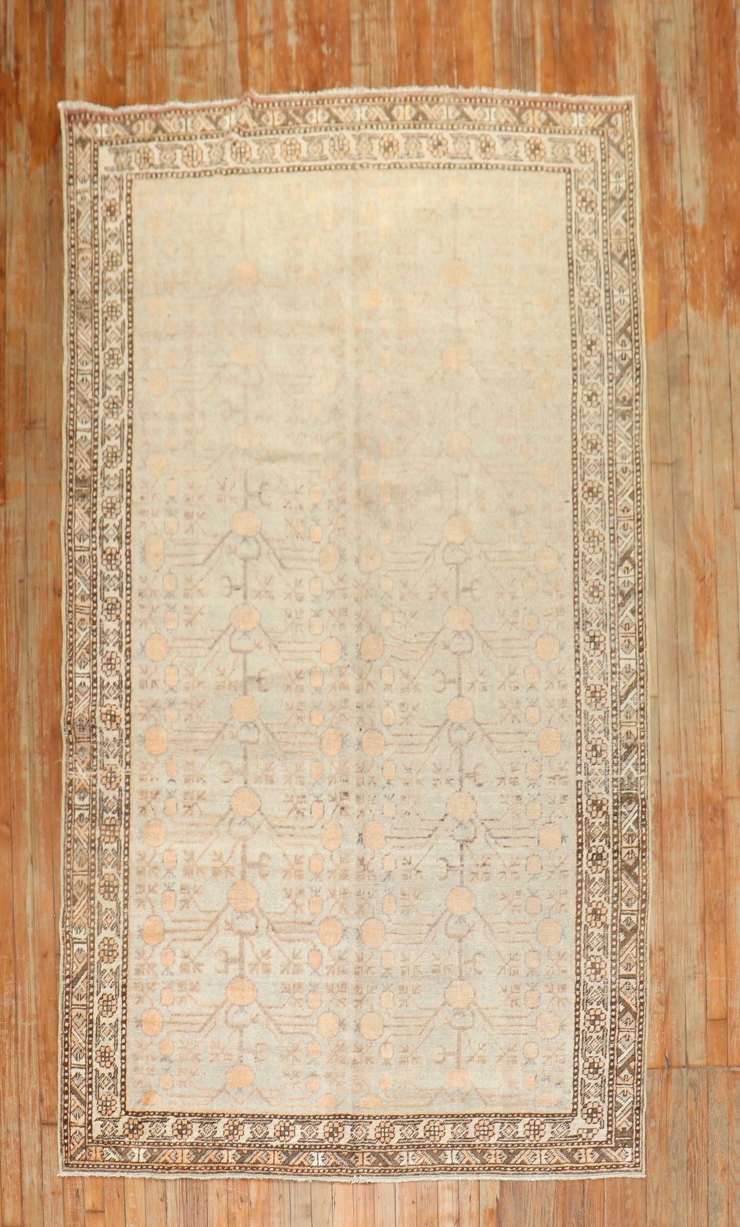 Early 20th century antique Khotan rug with a peach tone pomegranate motif on a light celadon green field

Measures: 5'5'' x 10'3''.