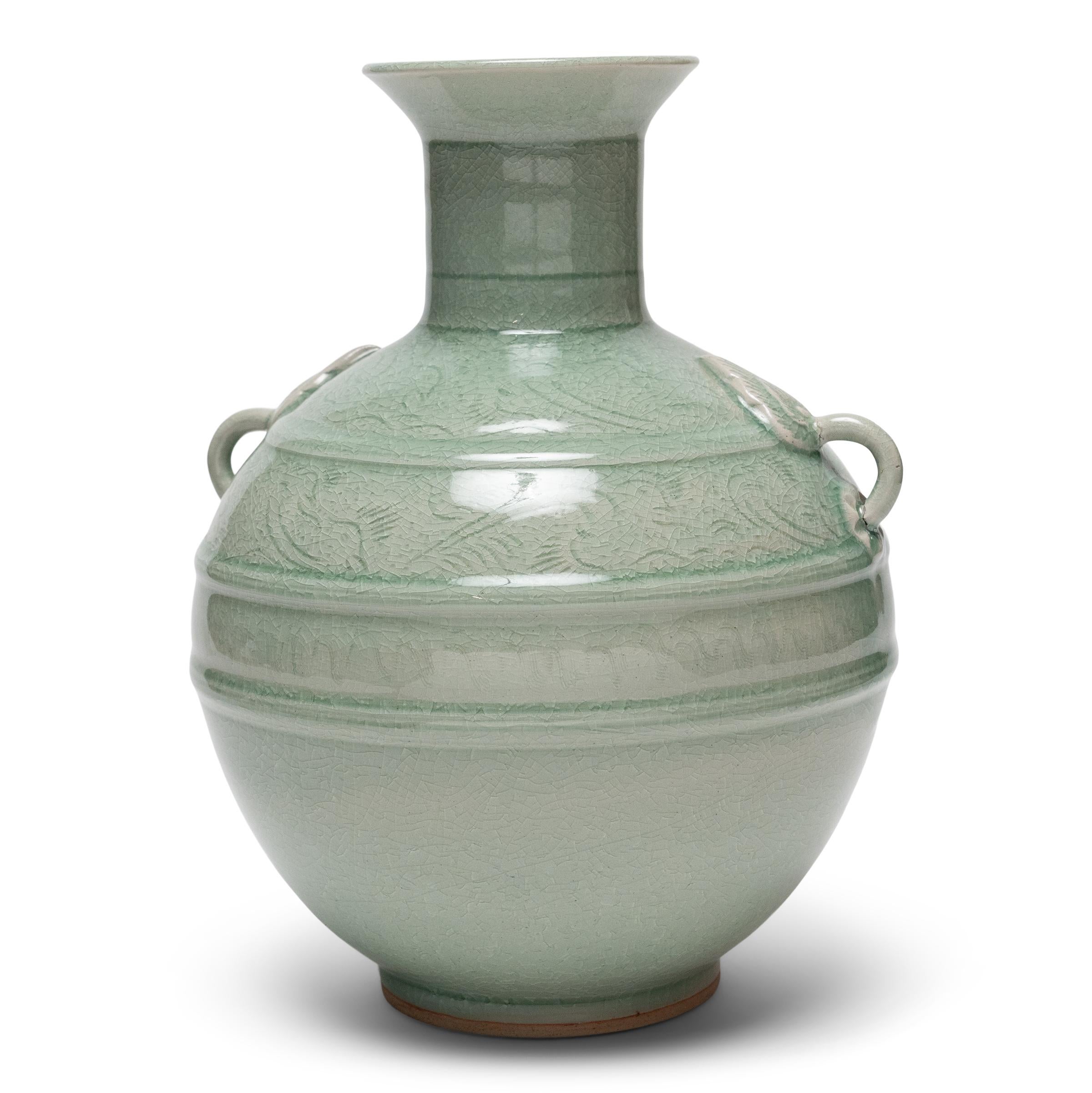 Described in ancient Chinese texts as the “moon dyed with spring water,” celadon ceramics are prized for their well-proportioned forms and luminous blue-green glazes. This vintage celadon vase was sculpted by artisans of the Mengrai Kilns in