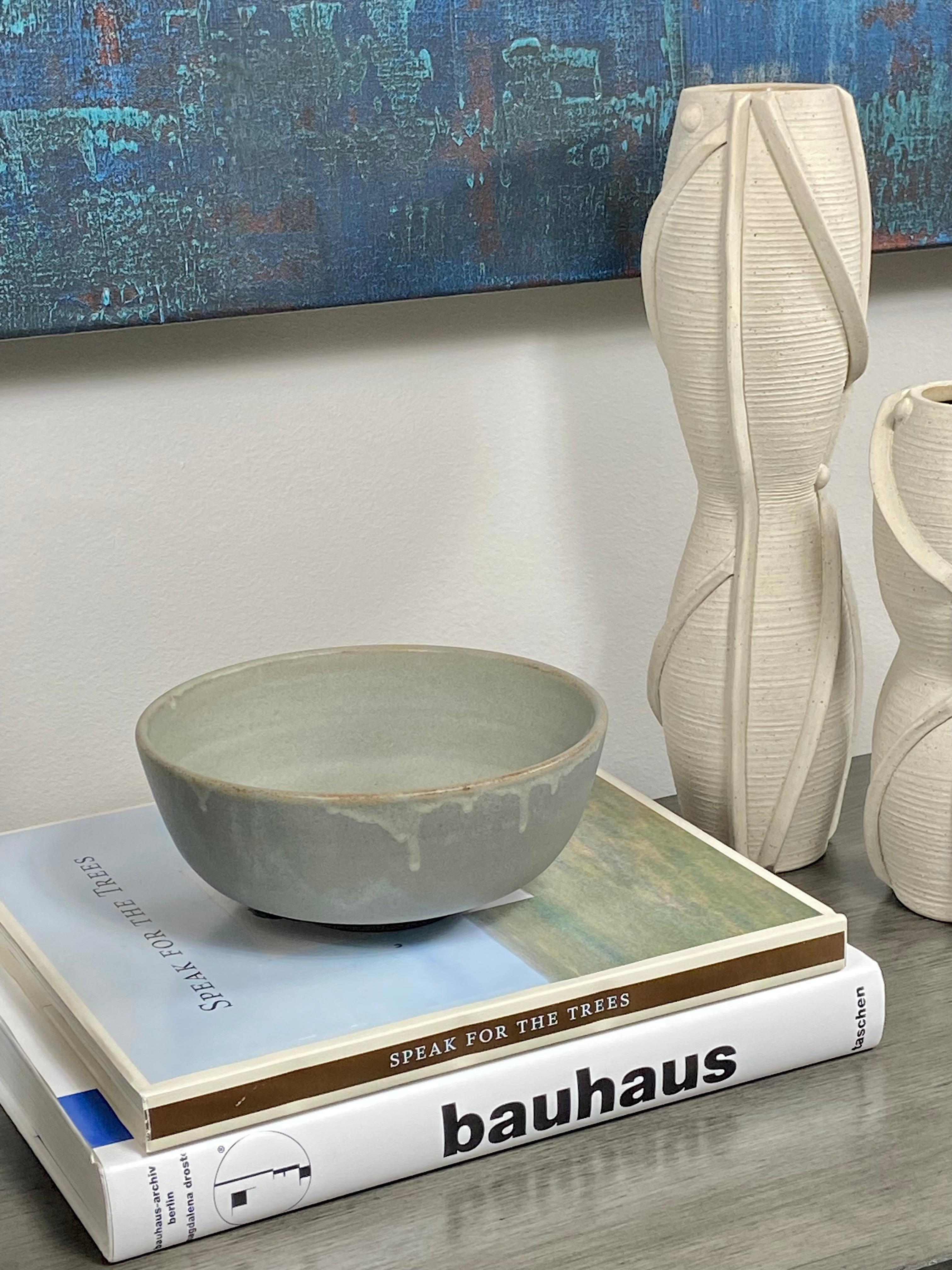 A lovely celadon glazed ceramic bowl. The intentional drip glaze adds a dimensionality to this beautiful and serene bowl. It is watertight to that you can use it functionally or just let it stand alone as a beautiful object. 