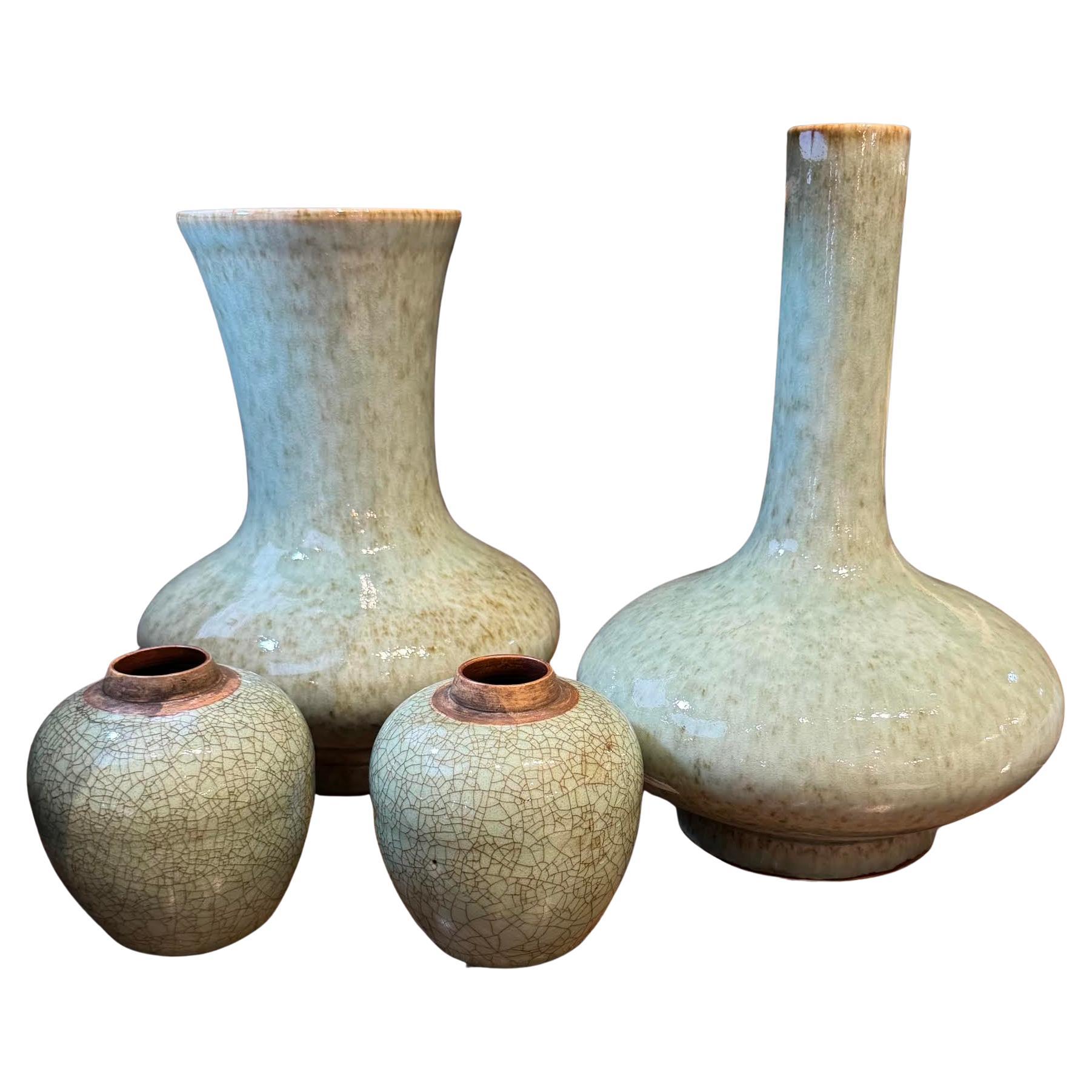 Contemporary Chinese small celadon crackle glaze vase.
Contrast tan band at opening.
The crackle glaze gives the vase the appearance of a vintage vase.
Two are available and sold individually.