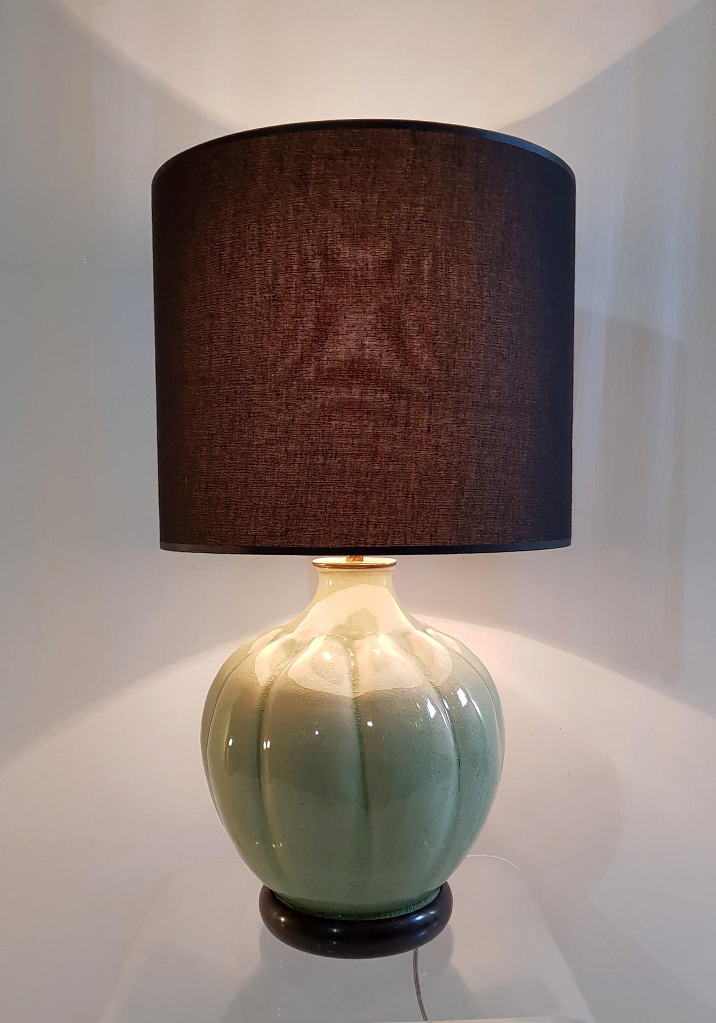 Table lamp in celadon green porcelain with an organic pumpkin shape and a brass stem to hold the brand new black lampshade.