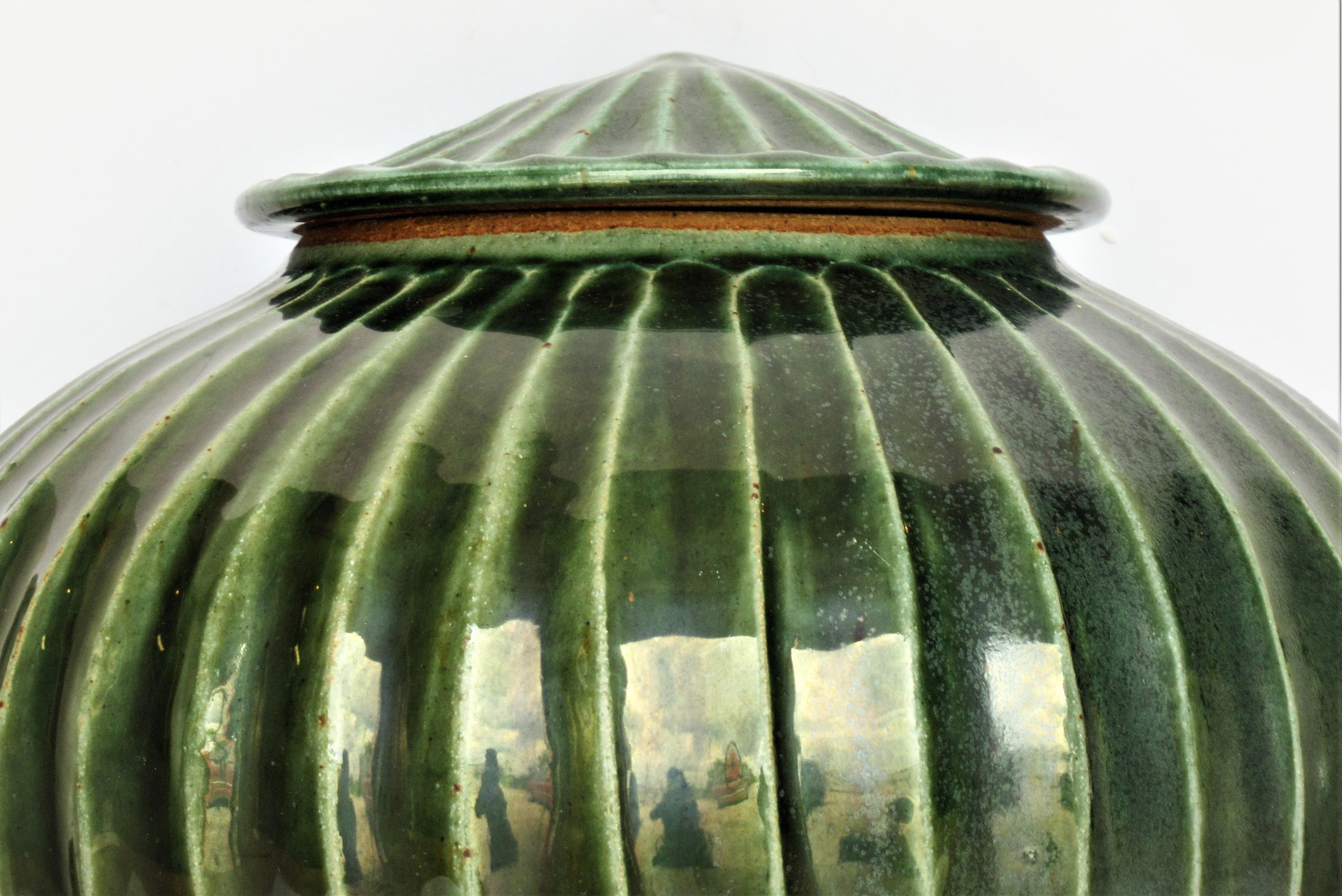 Hand thrown stoneware fluted bulbous gourd pumpkin shaped lidded vessel with a Japanese archaic modernist aesthetic and an exceptionally beautiful deep celadon jade green high glaze. Impressed makers mark on underside ( img. 8 / 9 ) but cannot