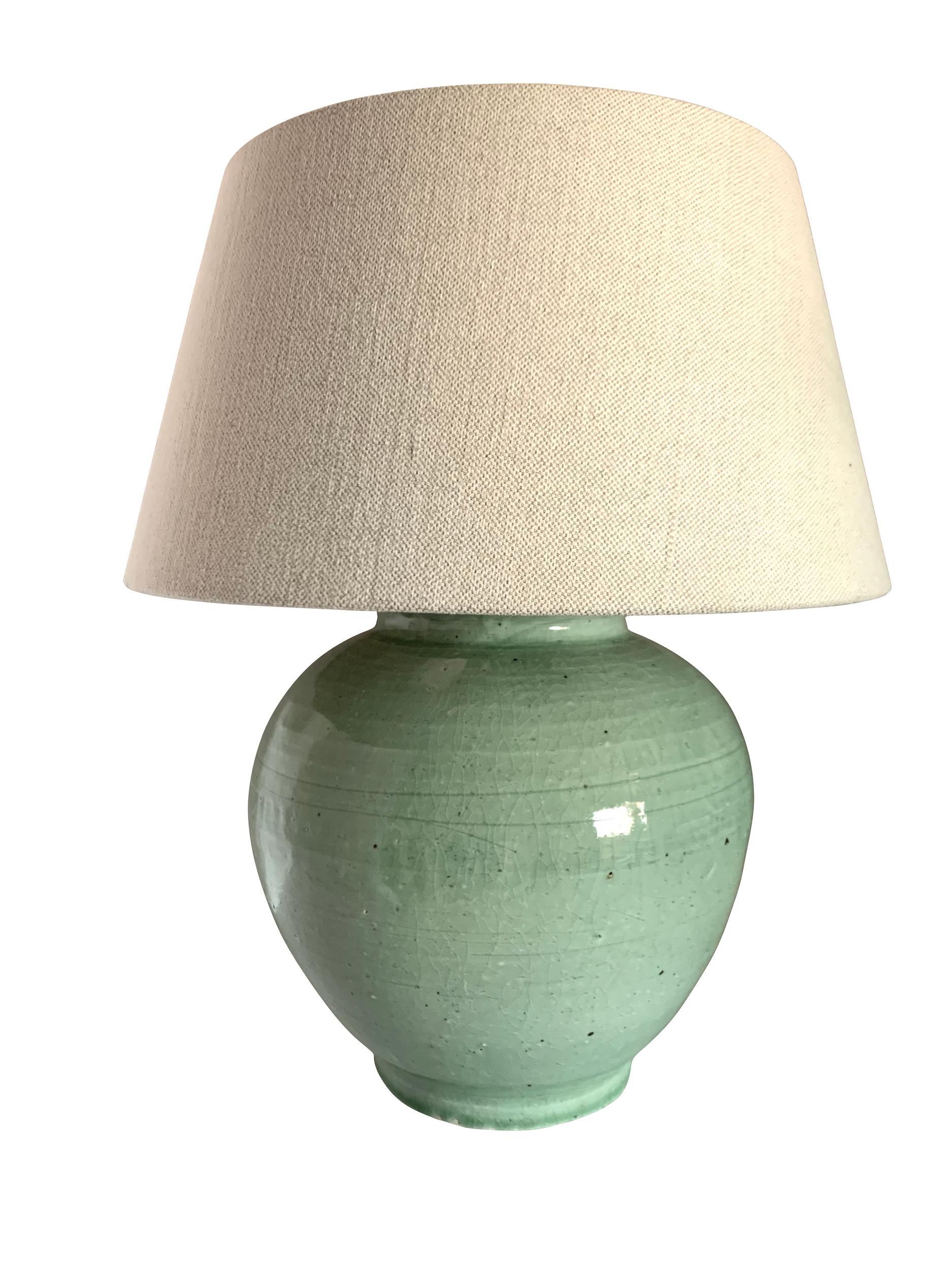 Contemporary Chinese pair celadon colored glazed lamps.
Classic ginger jar shape.
Base measures 10