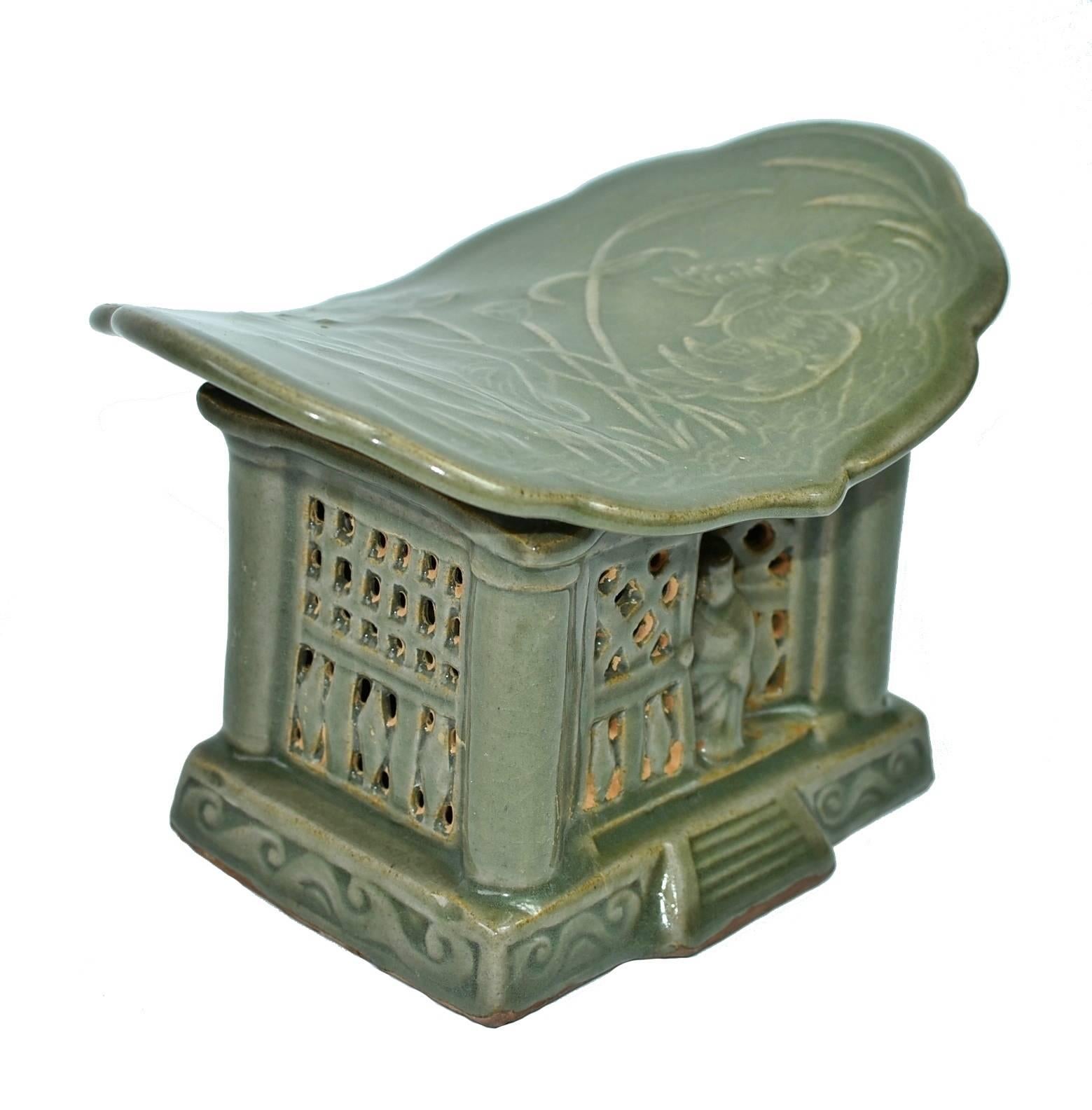 A song dynasty style porcelain pillow of the Long Quan kiln. The Long Quan kiln is one of the most important Song dynasty kilns. Started 1600 years ago, it produces celadon green and lotus leaf green glazed pieces with subtle under-glaze