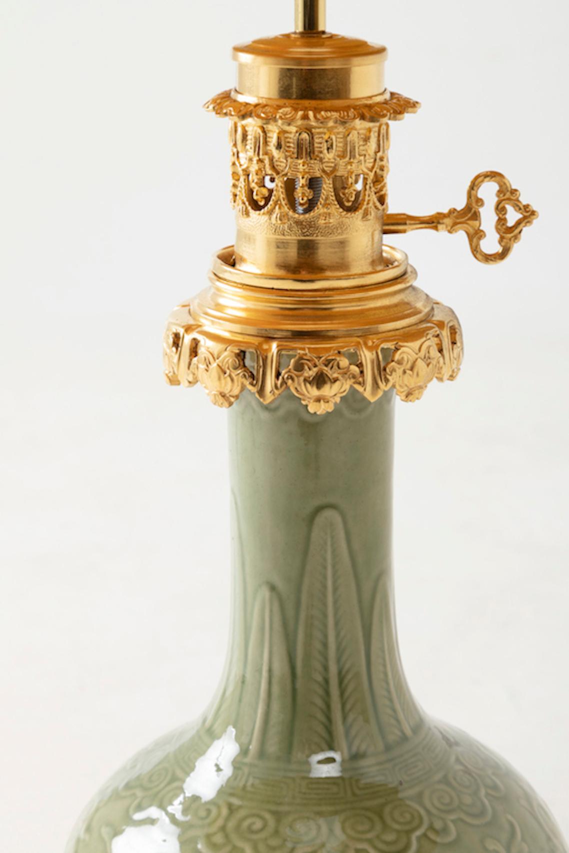 Chinoiserie Celadon Porcelain Lamp with a Relief Decor and Gilt Bronze Mount, circa 1880
