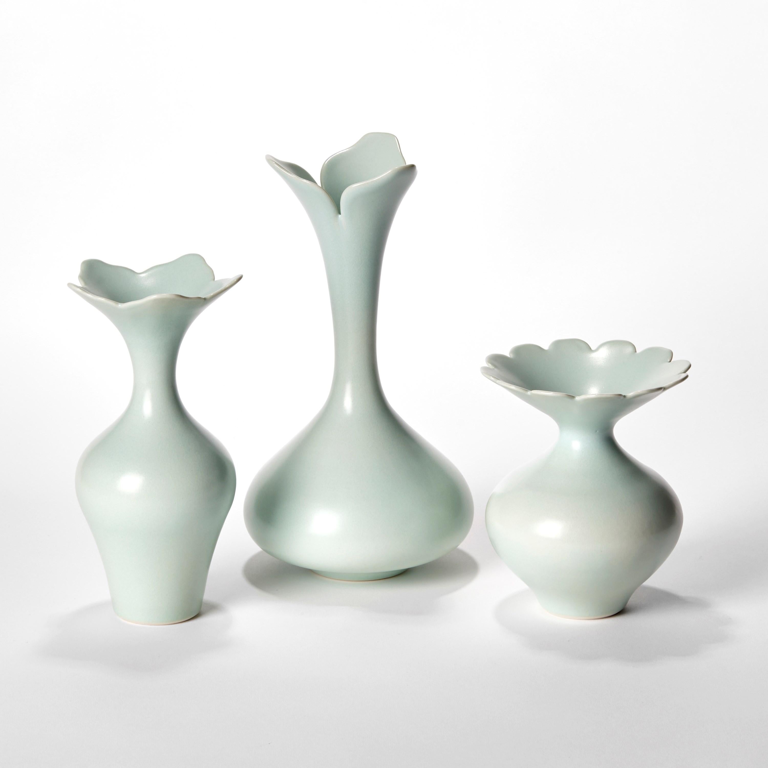 'Celadon Trio’ is a unique collection of porcelain sculptural vessels by the British artist, Vivienne Foley.

Left to right in the first image:

Celadon Foliate Rim Vase  H 20.5 cm W 10 cm D 10 cm 
Celadon Tall Trillobed Vase  H 26 cm W 14 cm D 14