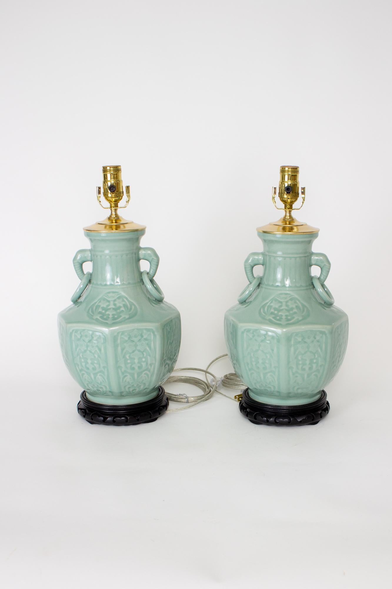 Custom Lamps made from 20th Century Chinese vases. Two elephant handles with rings. Octagonal shape with ornamented panels. Excellent condition. All brass hardware and carved wooden base. Single standard base socket. Silver wire. Newly wired with