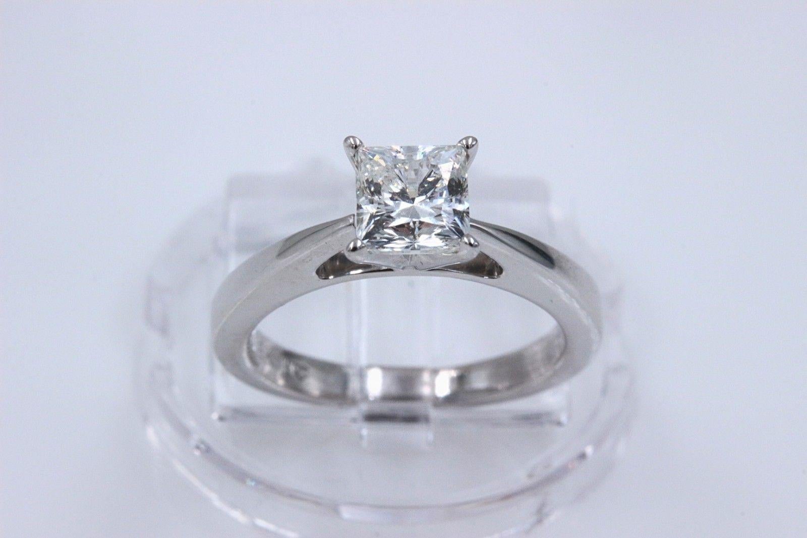 CELEBRATION DIAMOND
Style:  Solitaire Diamond Engagement Ring
Serial Number:  CEL567131
Metal:  18K White Gold
Size:  6 - sizable
Total Carat Weight:  1.09 cts
Diamond Shape:  Princess - Modified Square Brilliant
Diamond Color & Clarity:  H color,