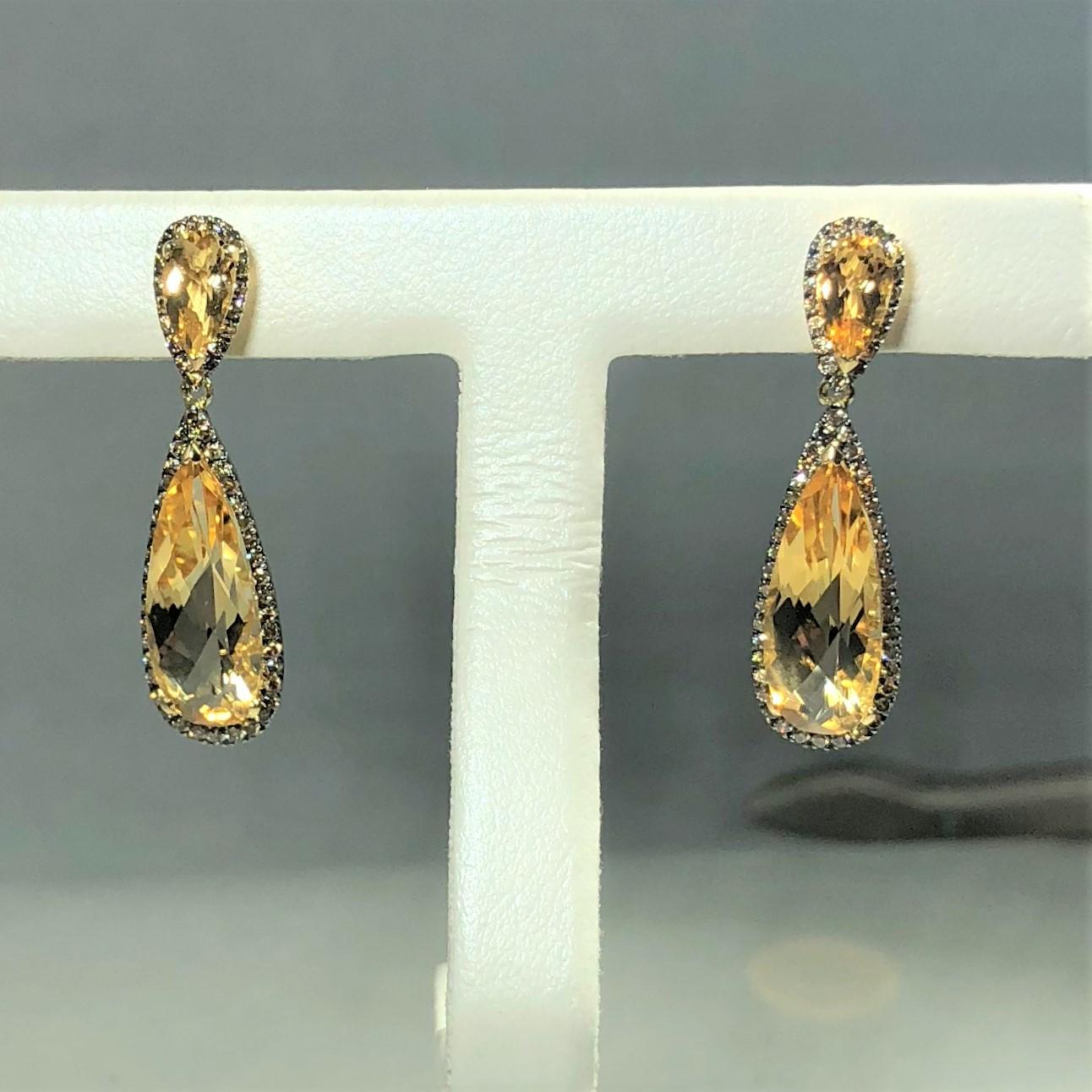 Celebrity 18 kt yellow gold Cognac diamond and citrine drop earrings. These gorgeous earrings are created in 18 karat yellow gold, weight 5.4 grams. Round Cognac diamonds surround two pear shaped  pale yellow/ orange Citrine. Total carat weight for