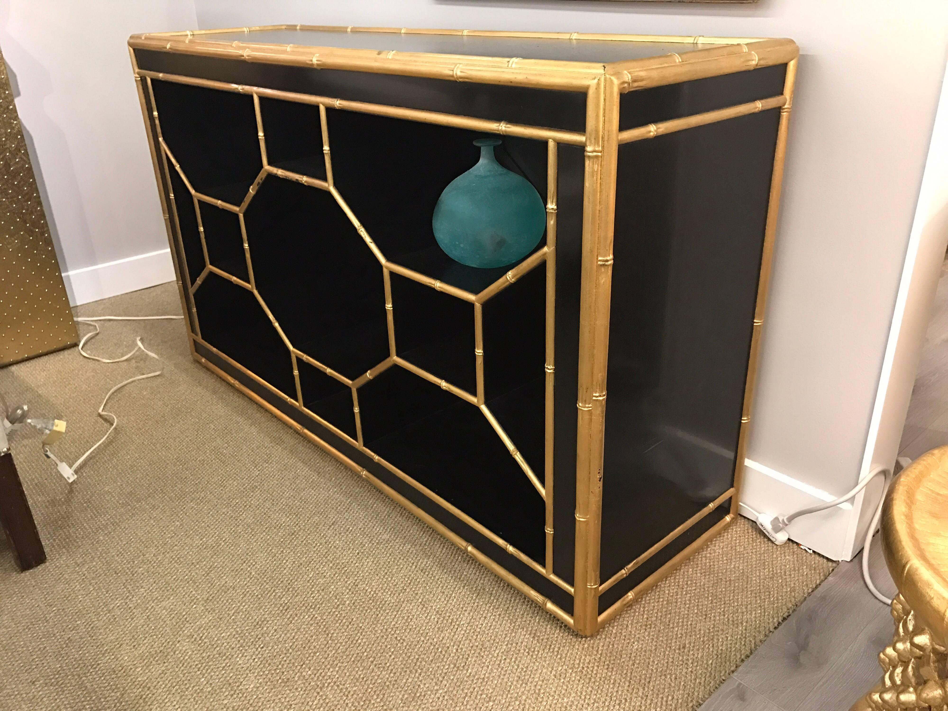 Great looking chinoiserie style black credenza with all open storage and trimmed in a gold gilt faux bamboo.  Designed by Celerie Kemble for Henredon.
