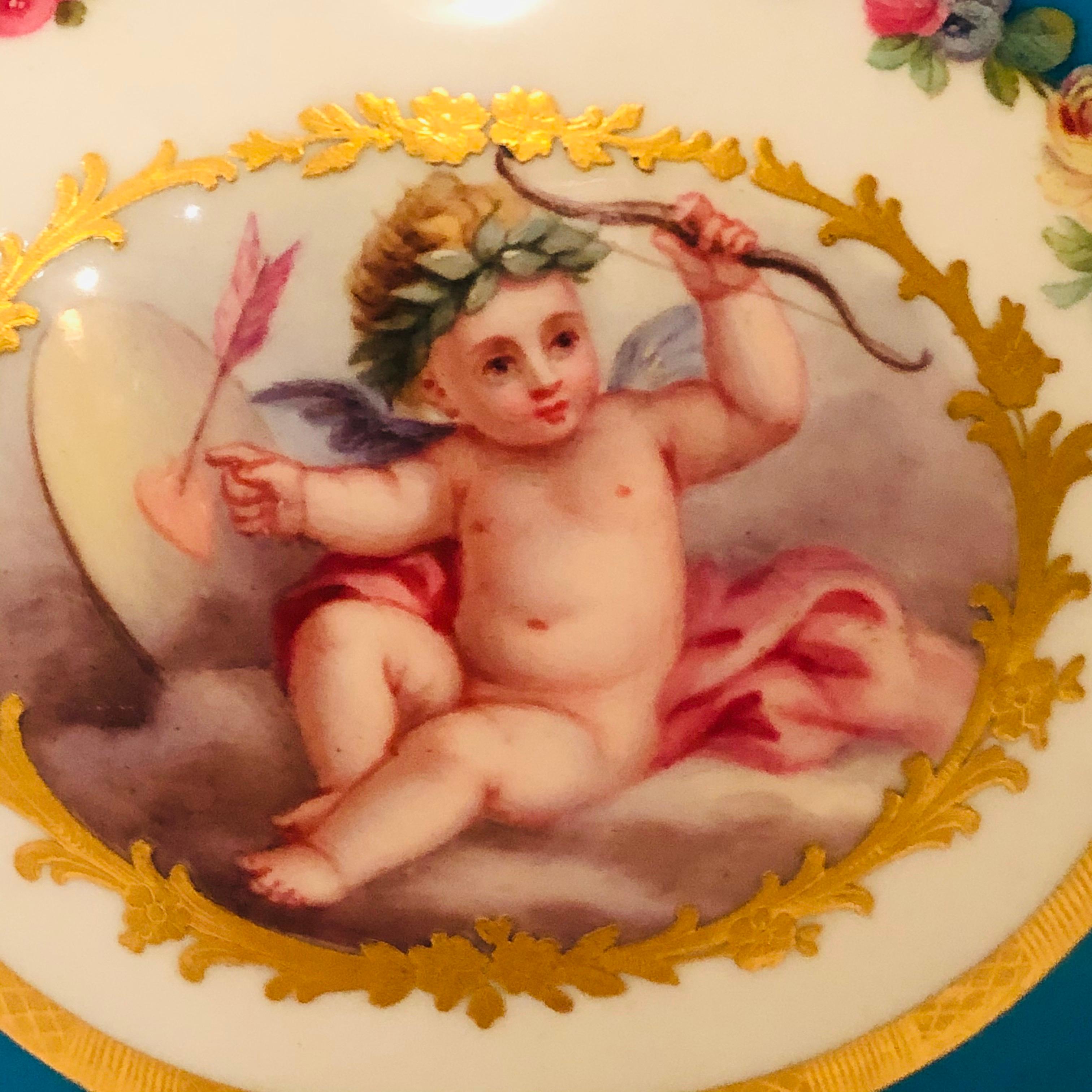 I would like to offer you this absolutely wonderful celeste blue Minton urn. Minton made a number of pieces after Sèvres porcelain pieces, and this urn is a great example. The artwork on this urn is spectacular. It has two paintings of cherubs, one