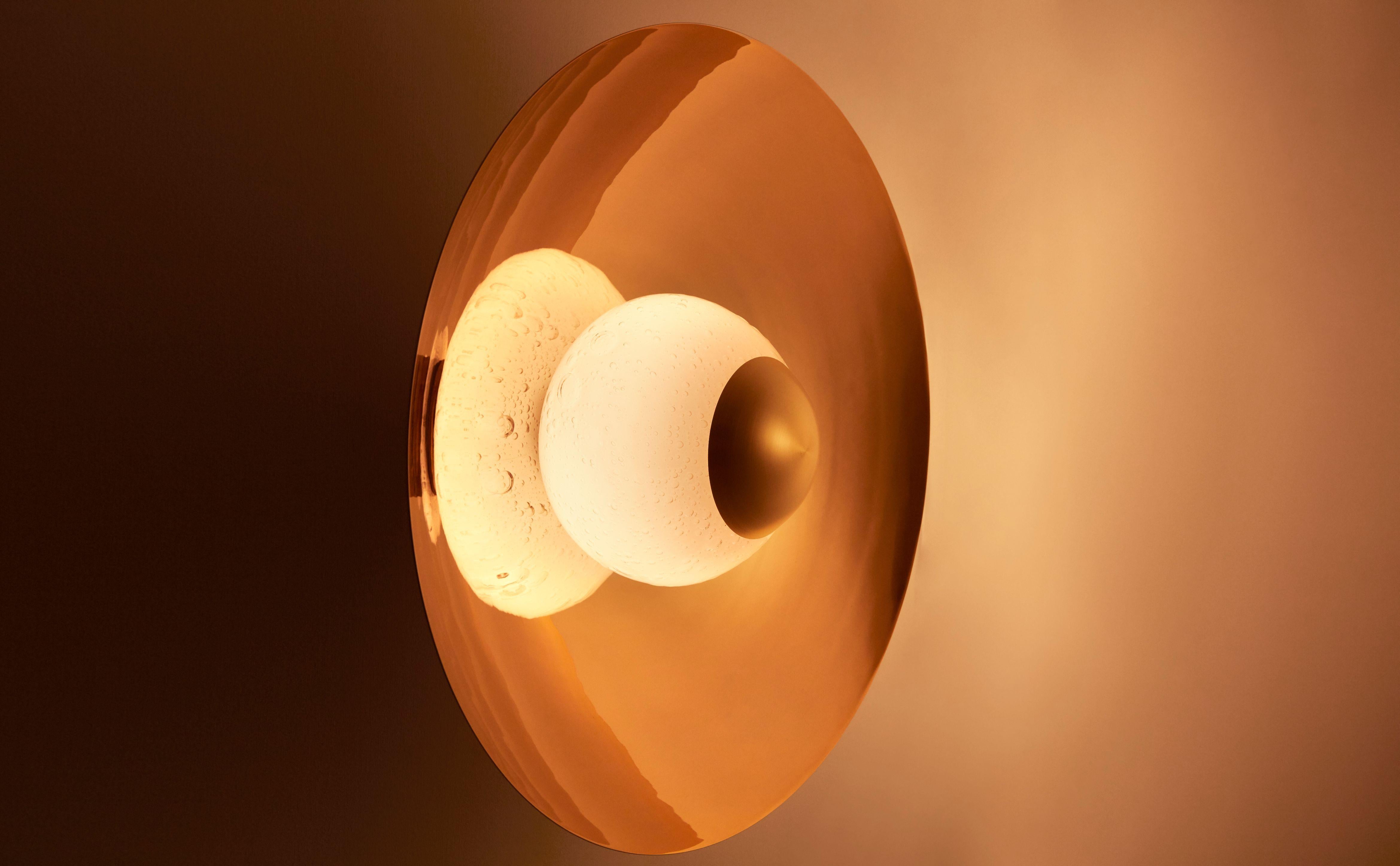 Céleste wall lamp by Mydriaz
Dimensions: diameter 60 x depth 34 cm
Materials: Bras and glass
Finishes: Golden-plated polished brass, white nickel finish on polished brass, black nickel finish on polished brass
7 kg

Our products are handmade