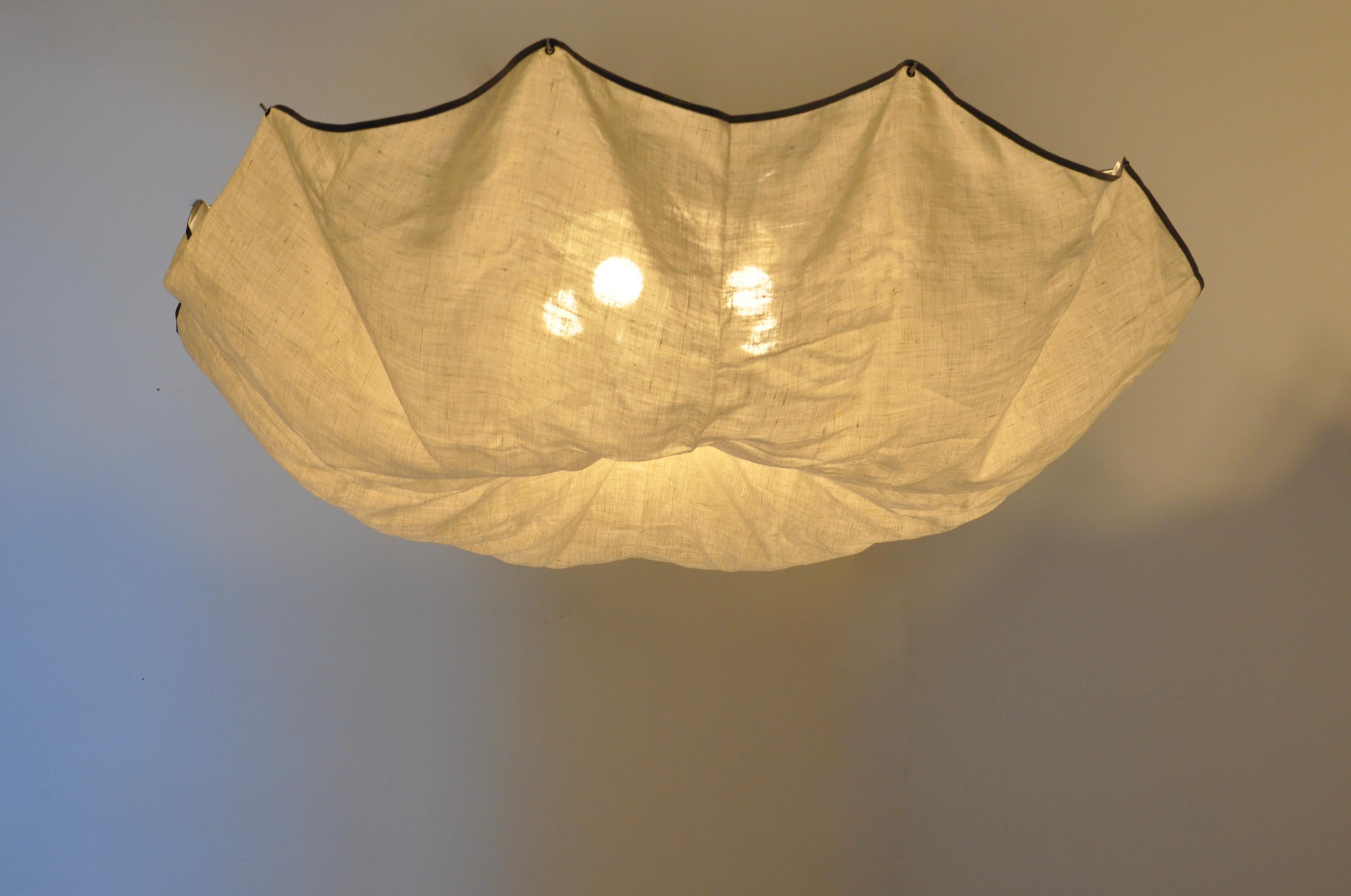 Ceiling light in white linen fabric and aluminum. Stamped Flos. Wear due to time and age. 