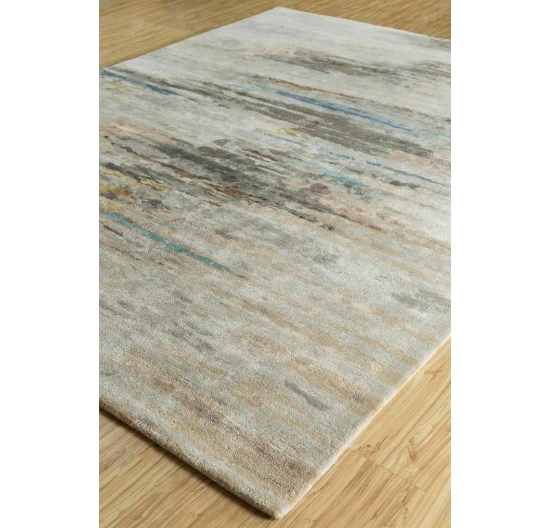 Parti per un viaggio celestiale con il nostro Tappeto moderno trapuntato a mano, che ricorda un capolavoro cosmico realizzato a mano nell'India rurale. Come un dipinto etereo, immagina mondi invisibili con tinte pastello e forme enigmatiche che si