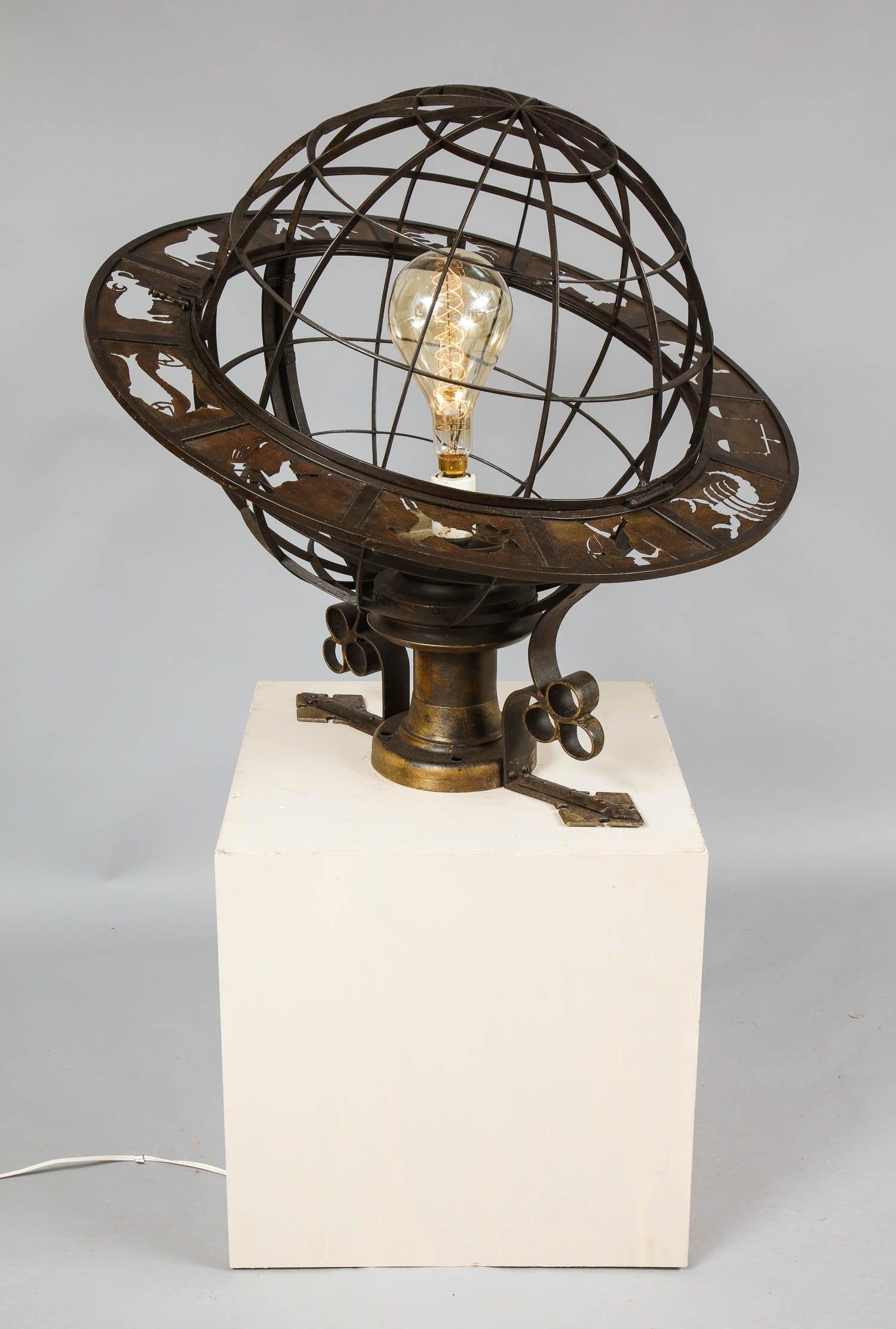 Unusual American wrought iron and bronze light fixture in the form of a globe with Zodiac ring in pierced bronze probably designed by Cass Gilbert and made for the Hartford CT based department store G. Fox and Co, circa 1918. The original store was