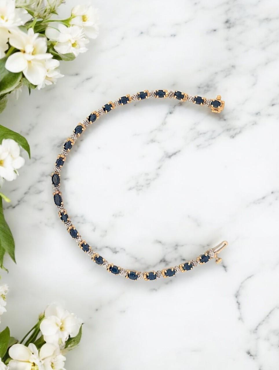 Crafted in solid 10K yellow gold, this stunning sapphire bracelet features 3.80 carats of natural deep blue sapphires, accented by 0.03 CTW natural diamonds for a subtle touch of brilliance. Designed with a delicate yet luxurious silhouette, this