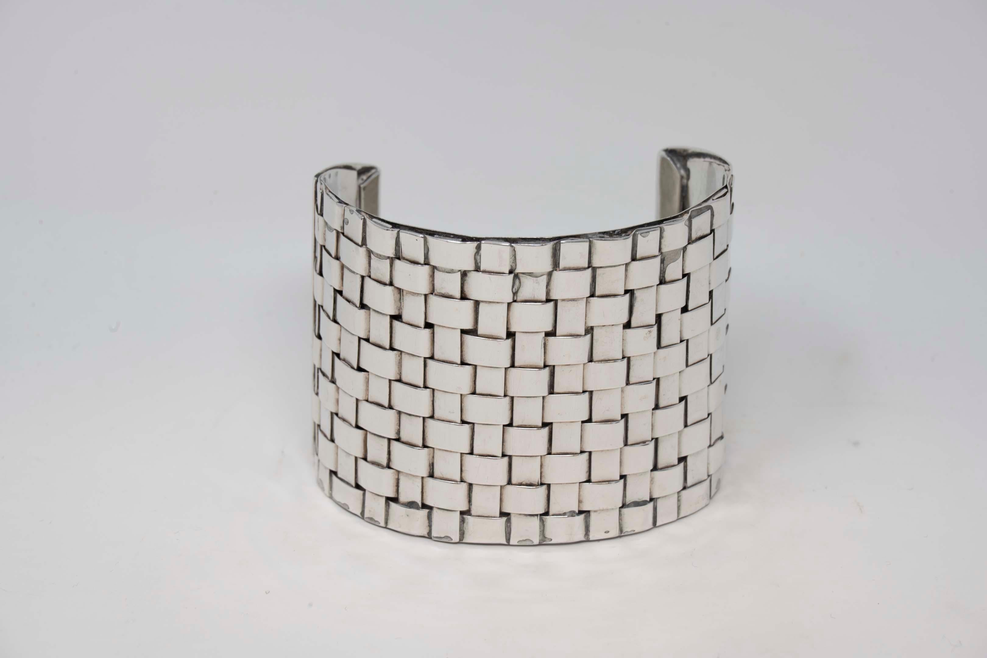 Celia Sebiri sterling silver cuff bracelet signed Sebiri Sterling, prominent New York designer active from 1970-1990. Bracelet measures 2 1/2 inches x 2 inches, preowned. Weighs 86.6 grams, in good condition.
