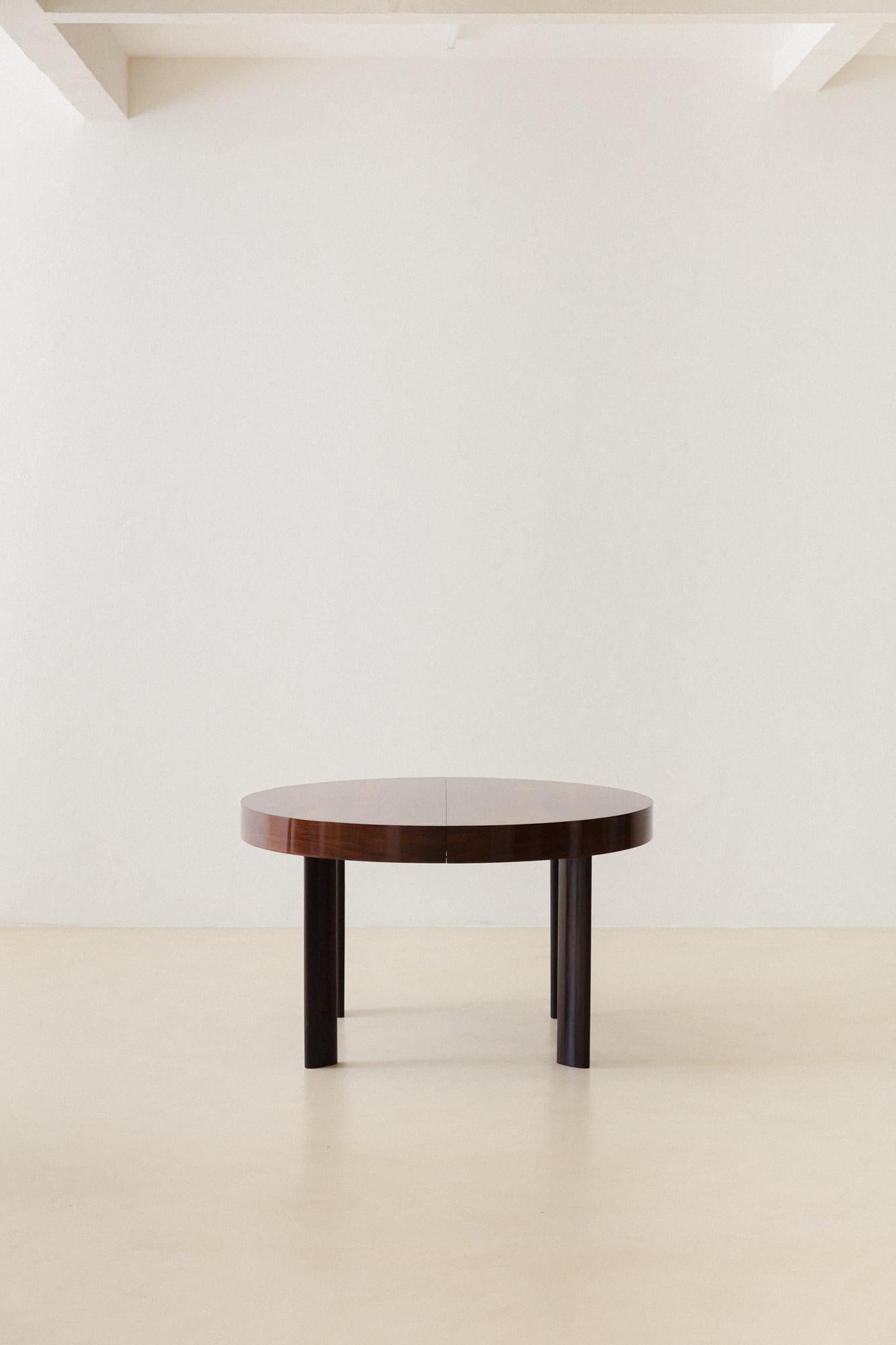 This Expandable dining table was produced by the Brazilian company Celina Decorações in the 1960s. The round table is made of Rosewood and has four seats, expandable for six seats by a very well-designed engine in the center.

The table is