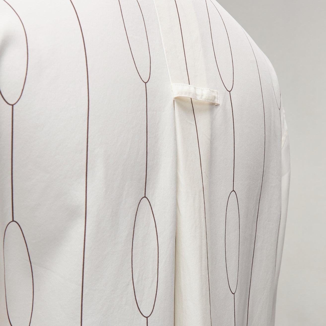 CELINE 100% silk cream oval linear half placket blouse shirt FR34 XS
Reference: EALU/A00006
Brand: Celine
Material: Silk
Color: Cream
Pattern: Abstract
Closure: Button
Extra Details: Pleat and tab detail at back below collar.
Made in: