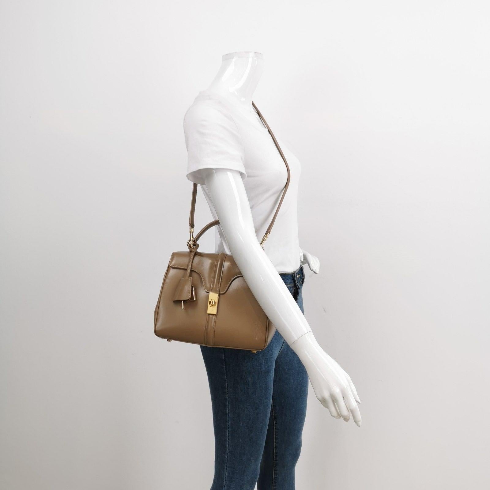 Celine 16 Bag Small Beige Smooth Calfskin Leather
  These are professional photos of the actual bag.
  This Celine 16 Bag is elegantly designed, showcasing a unique blend of classic and modern elements. It boasts a front clasp, top handle, and long