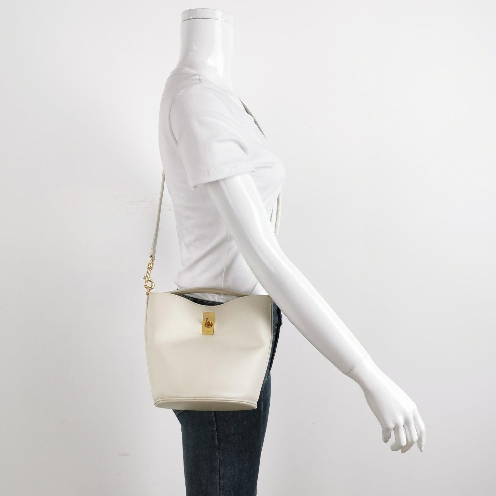 Celine 16 Bucket Bag White Calfskin Leather Crossbody Bag
  These are professional photos of the actual bag.
  This Celine 16 Bucket Bag is elegantly designed, showcasing a unique blend of simplistic modern elements. Dressed in a stunning natural