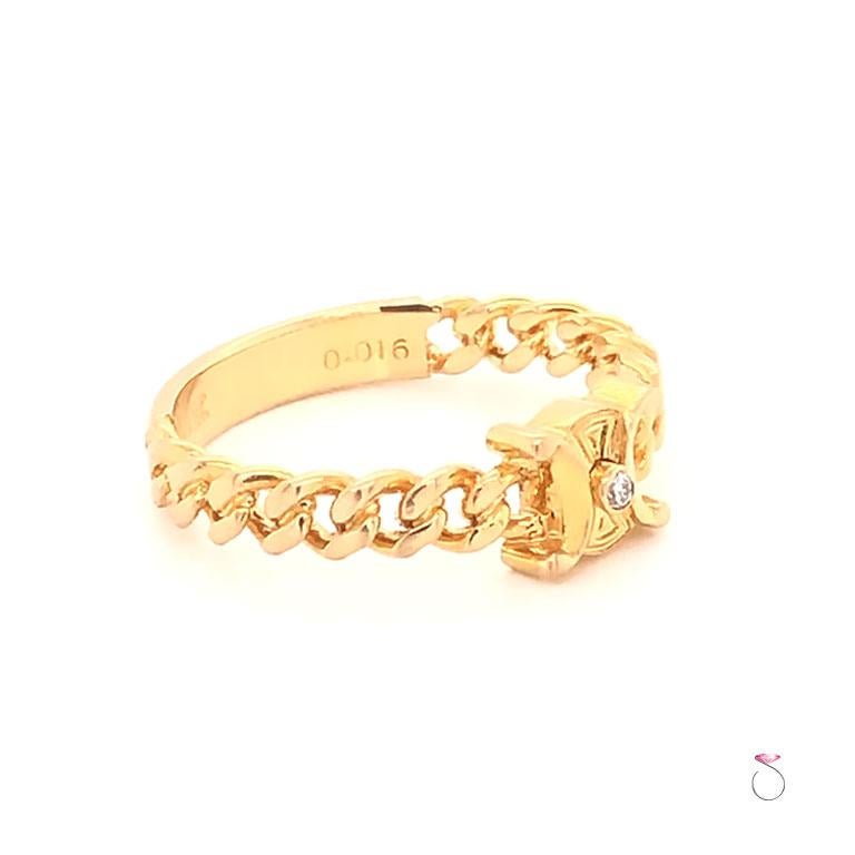 Authentic Celine Logo Diamond ring in 18k yellow gold. This gorgeous Celine ring features the Celine logo at the center with a small round diamond bezel set at the center of the logo. The ring sides have a beautiful cuban link design. The diamond is