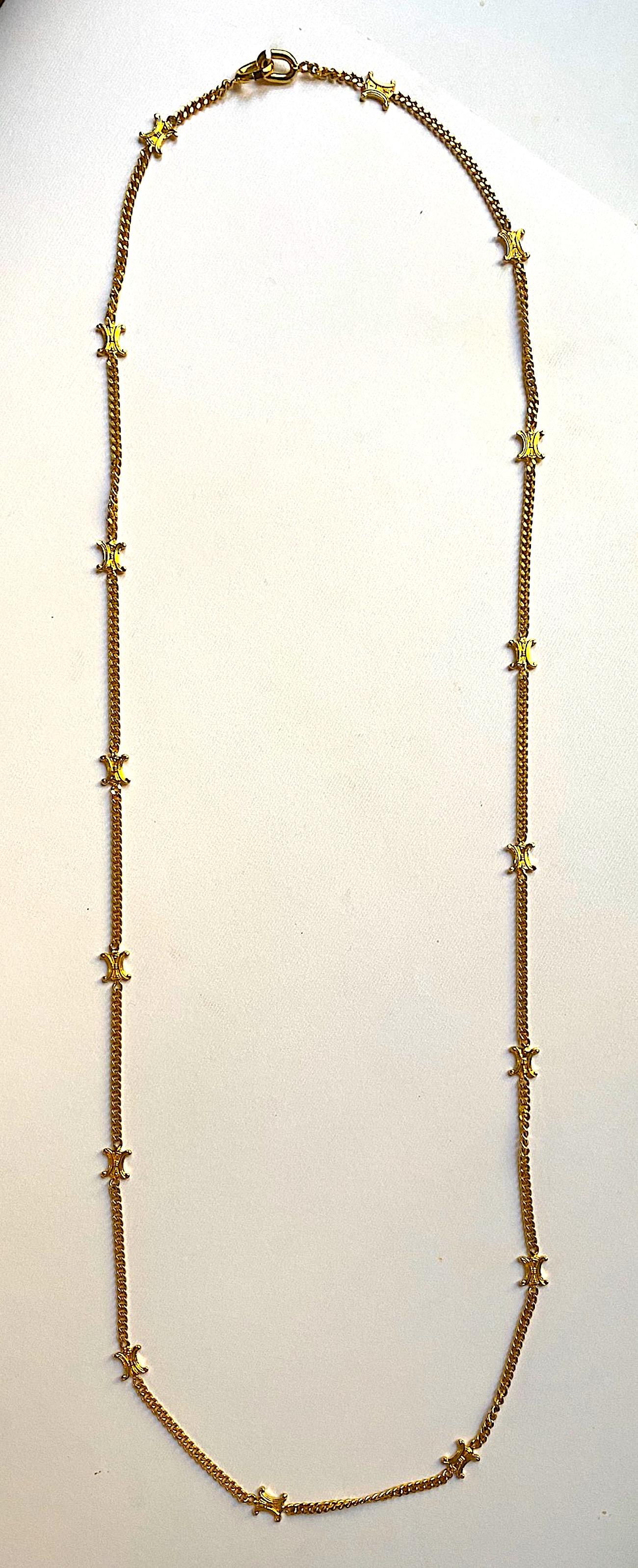 An elegant and Celine long gold necklace circa 1990. It measures 41 inches long. The gold plate necklace is comprised of 2 inch curb link chain 3 mm wide and 16 Celine logo spacers measuring .38 of an inch wide and high.The clasp is two oval links